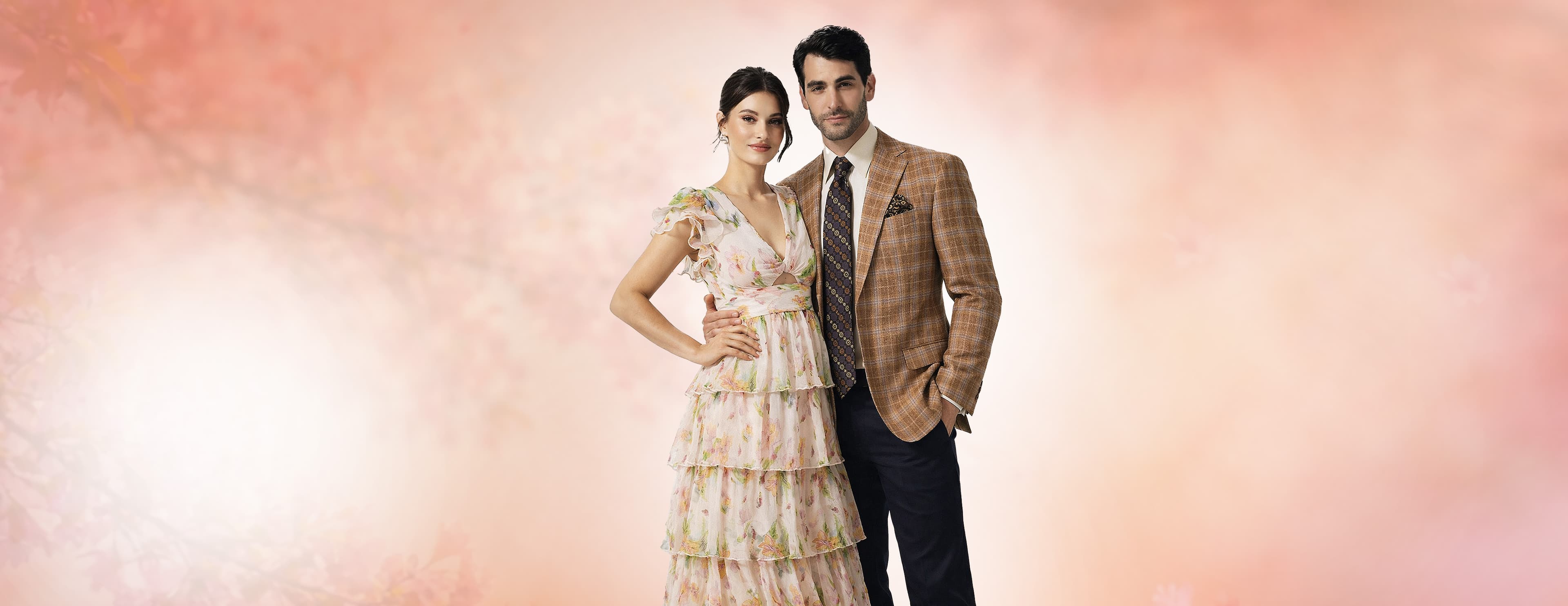 Elegant fashion couple in sophisticated attire - a man and woman showcasing luxury fashion in a premium setting with the Barcelino brand message 'It's a Visual World, All Eyes On You'