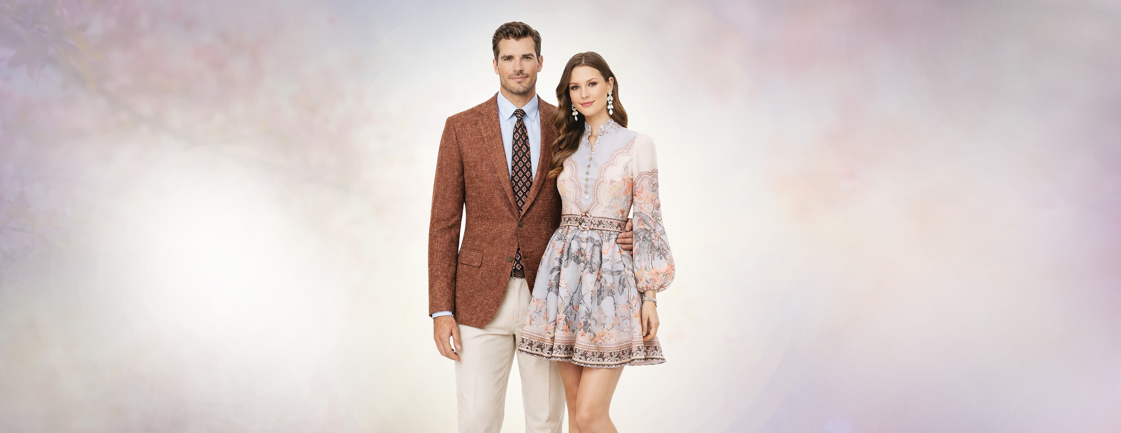 Elegant fashion couple in sophisticated attire - a man and woman showcasing luxury fashion in a premium setting with the Barcelino brand message 'It's a Visual World, All Eyes On You'