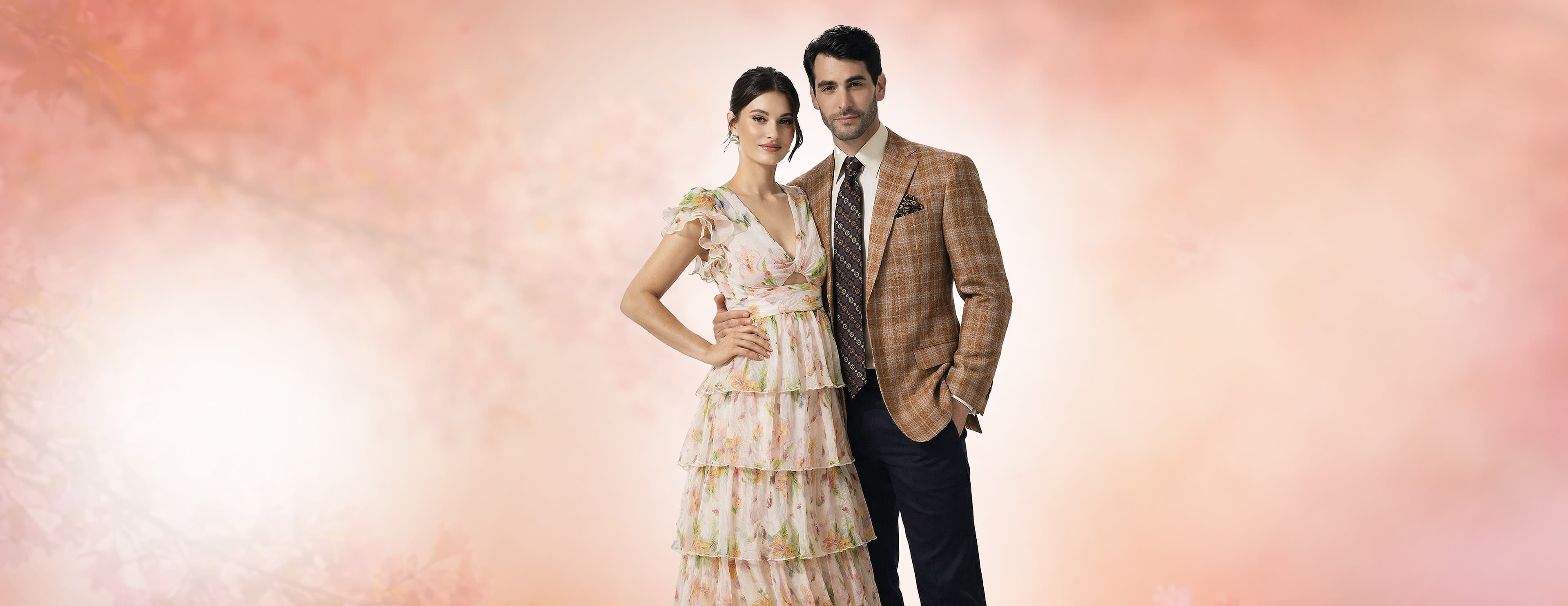 Elegant fashion couple in sophisticated attire - a man and woman showcasing luxury fashion in a premium setting with the Barcelino brand message 'It's a Visual World, All Eyes On You'