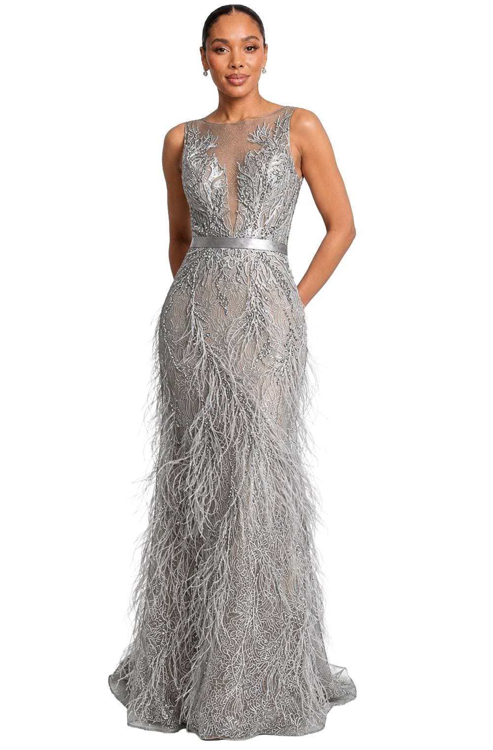 A woman wearing an elegant silver gown with intricate lace and feather detailing.