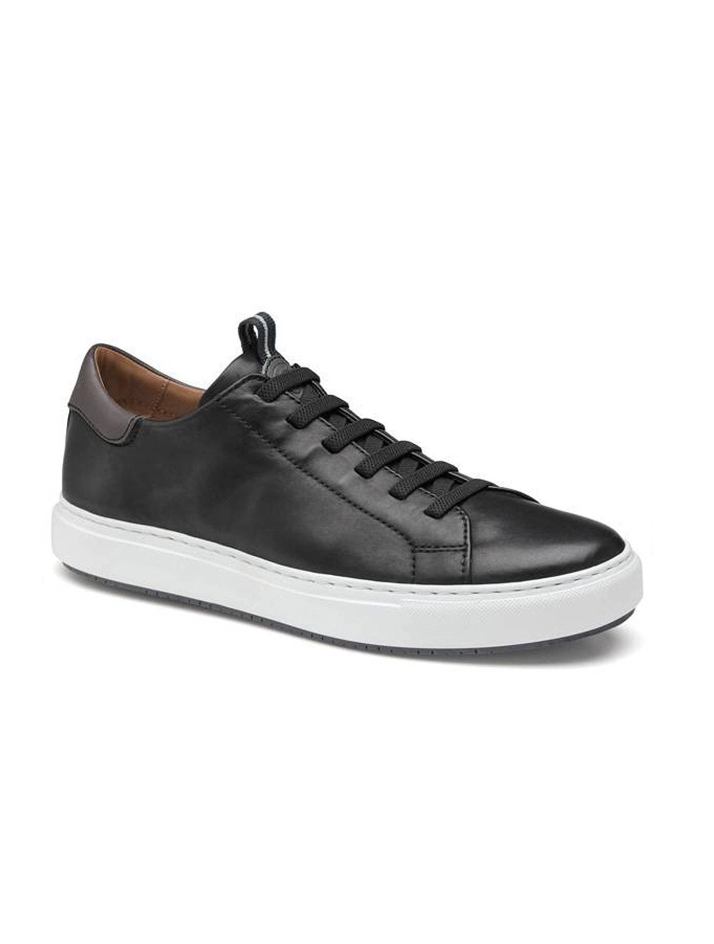 Black leather sneaker with white sole and black laces and brown detail on the back