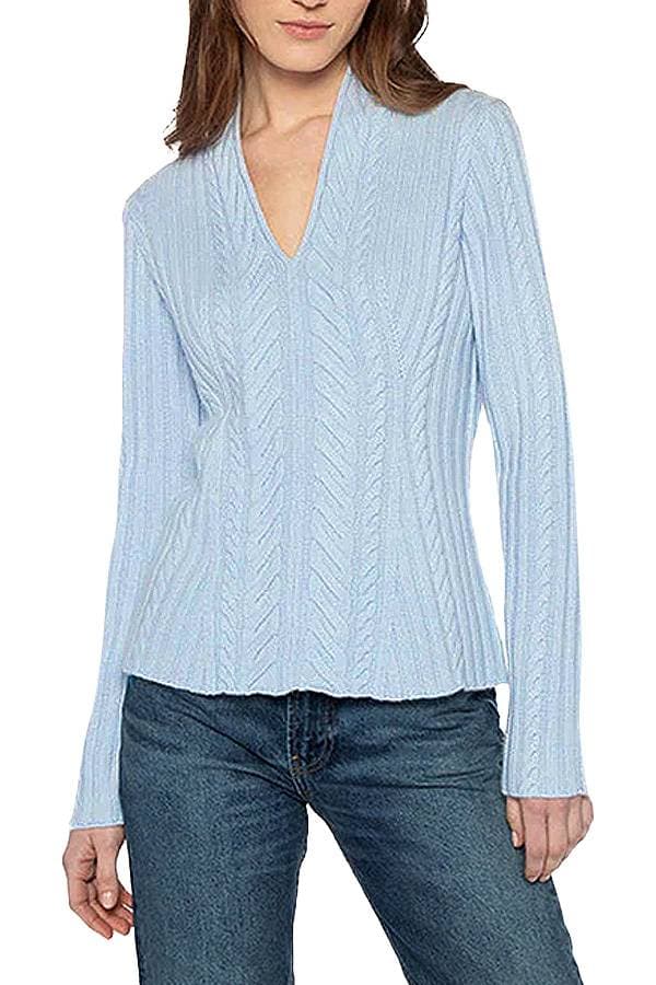 light blue sweater with a V-neckline and intricate cable knit pattern.