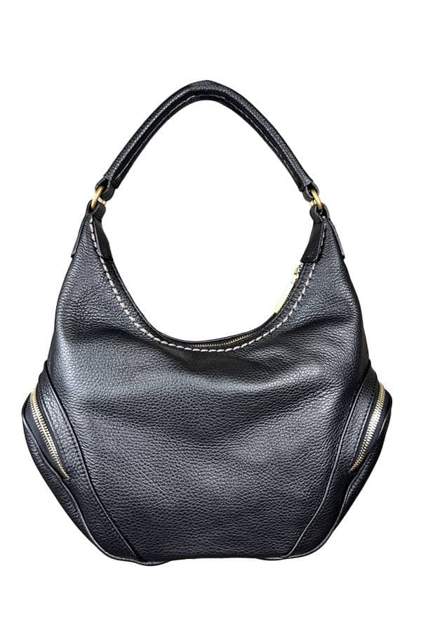 Back view of a black leather handbag with a single handle, gold zipper accents on both sides, and a spacious slouchy body.