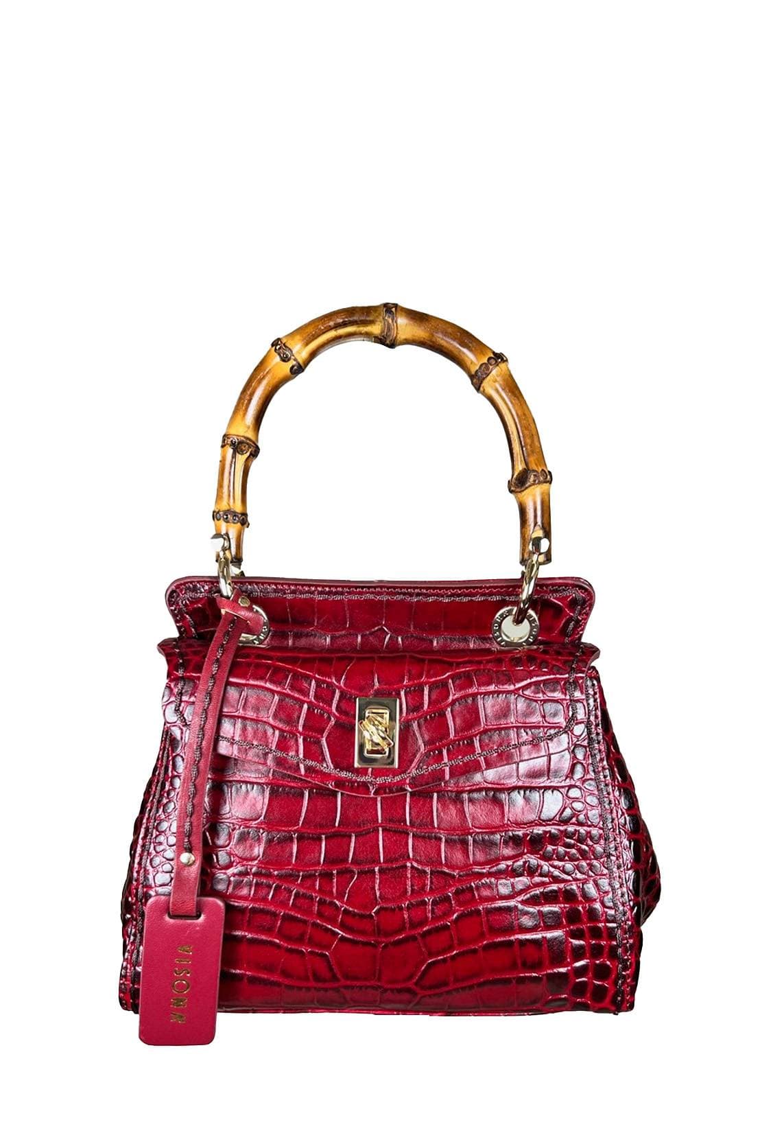 Structured handbag in glossy deep red crocodile-embossed leather with a bamboo top handle, gold-tone clasp, and matching red leather luggage tag.