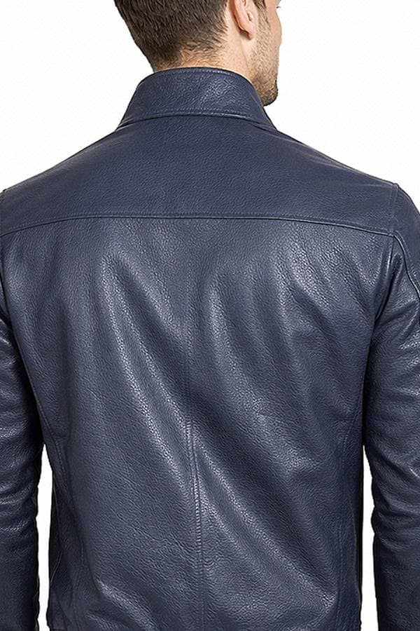 A person wearing a dark blue leather jacket seen from behind.