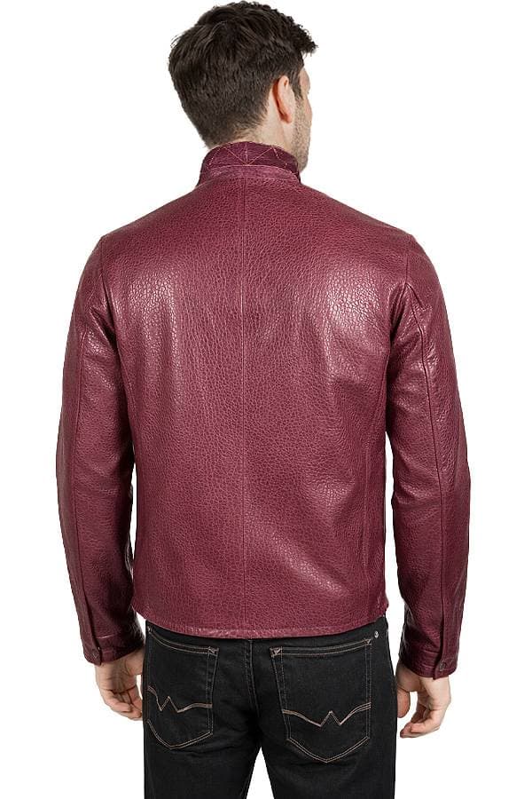 A person is wearing a textured maroon leather jacket viewed from the back.