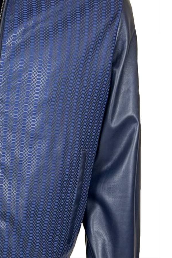 Close-up of a blue jacket with textured patterns and leather sleeves.