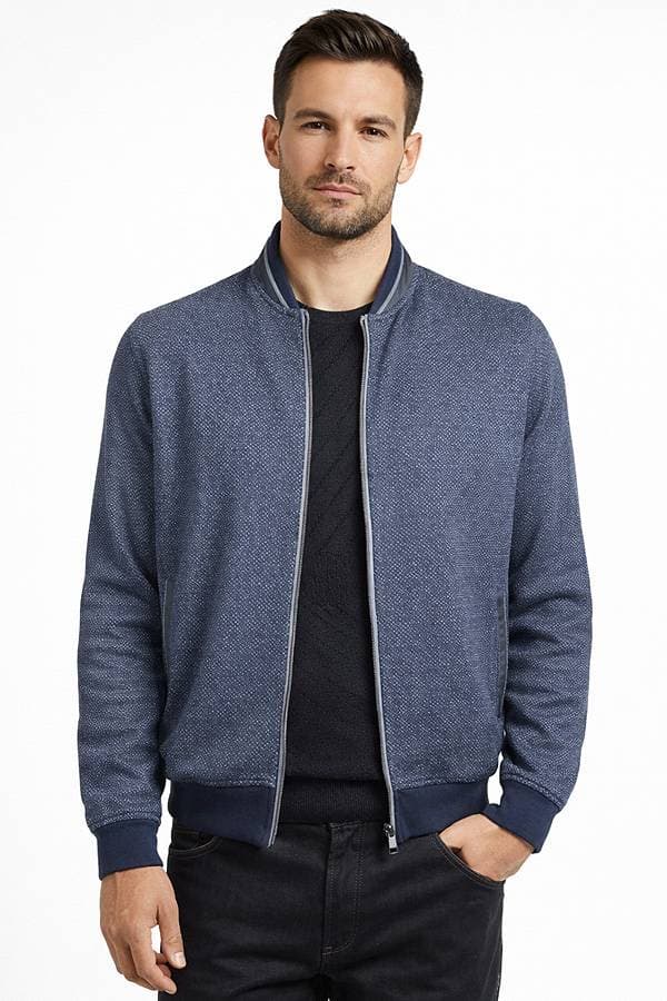 A man is wearing a blue zip-up jacket over a black shirt.