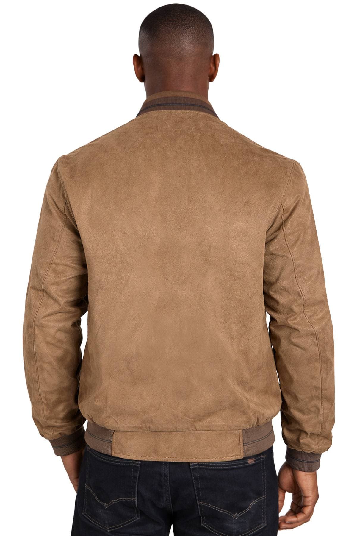 A person wearing a tan jacket and dark jeans, seen from the back.