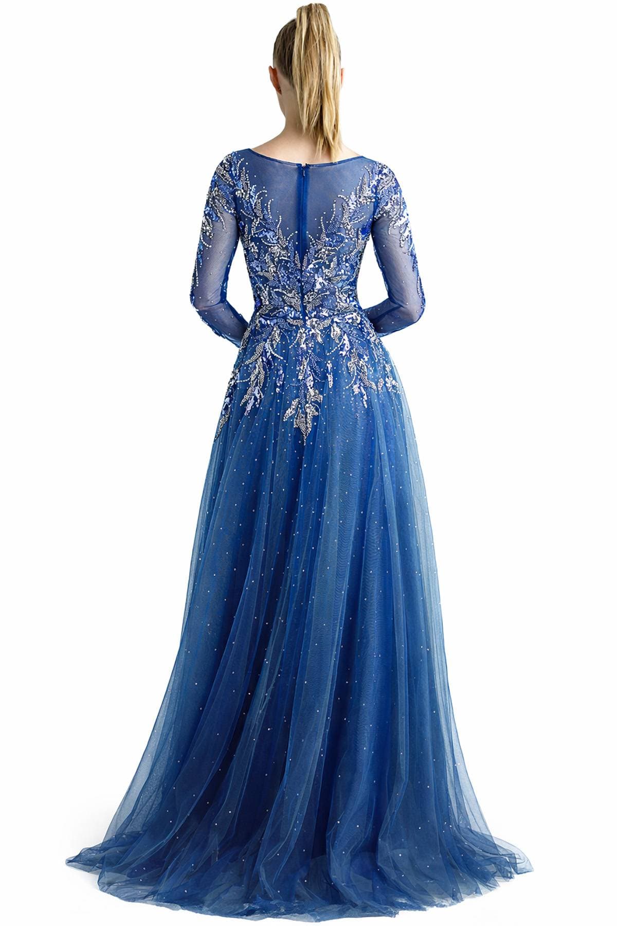 A woman in a long-sleeved, embroidered blue gown with a flowing skirt is seen from the back.