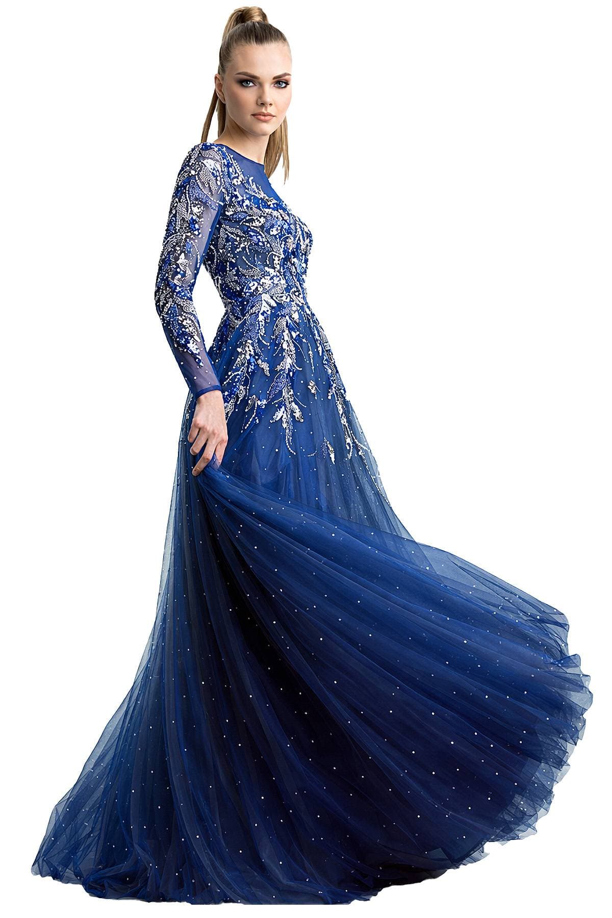 A woman wears a long, flowing royal blue gown adorned with silver embellishments and sheer sleeves.