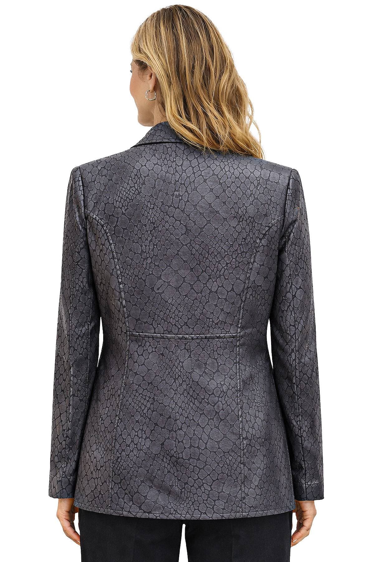 A woman with shoulder-length hair wearing a gray, snakeskin-patterned blazer seen from the back.