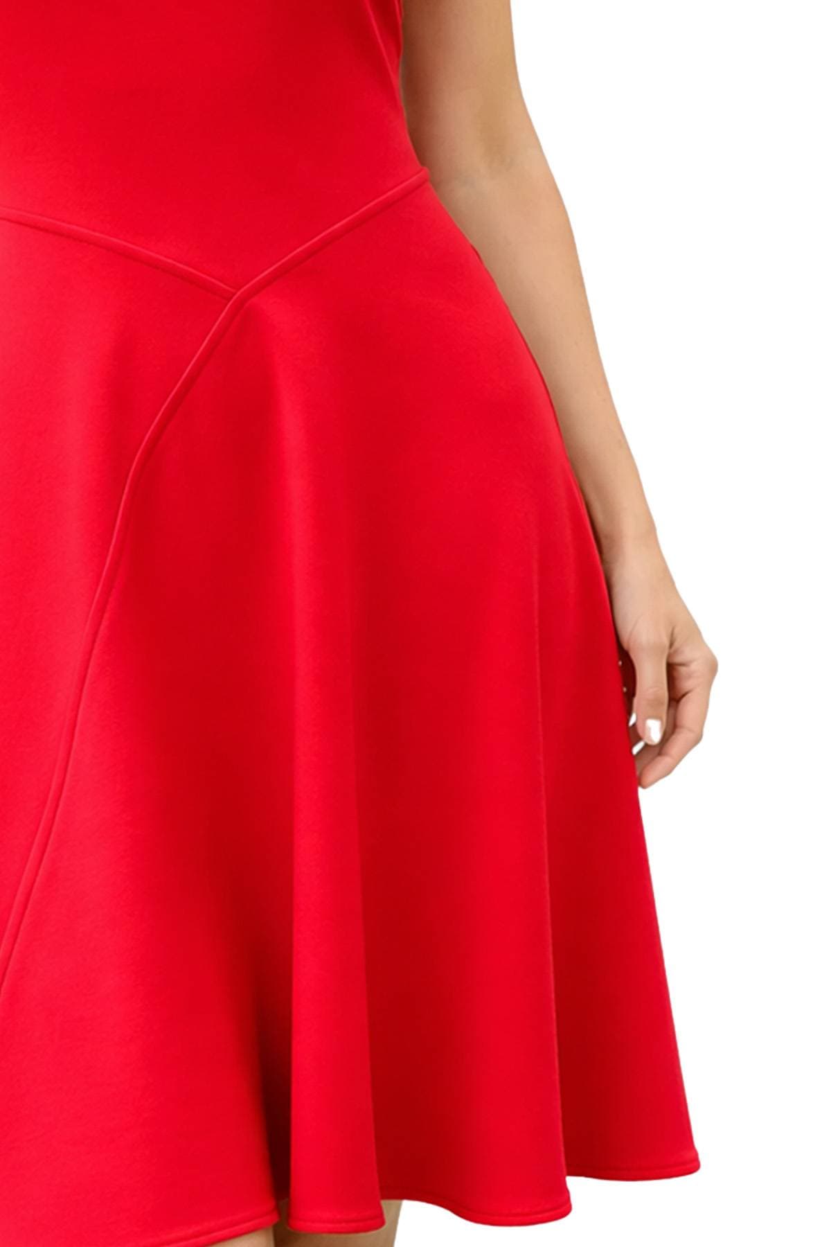 A person wearing a red sleeveless dress, showing part of an arm and hand.