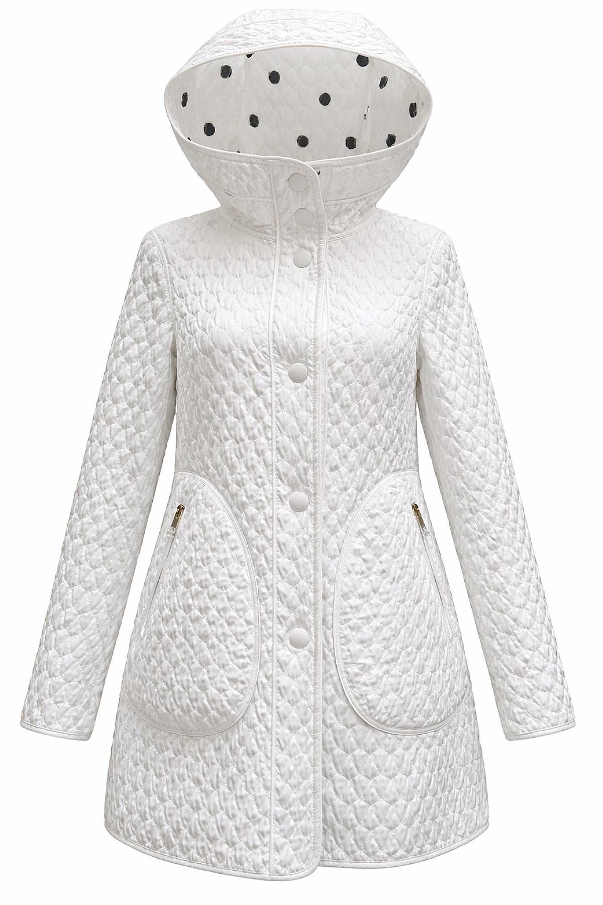 A white quilted coat with a hood lined with black polka dots and large front pockets.