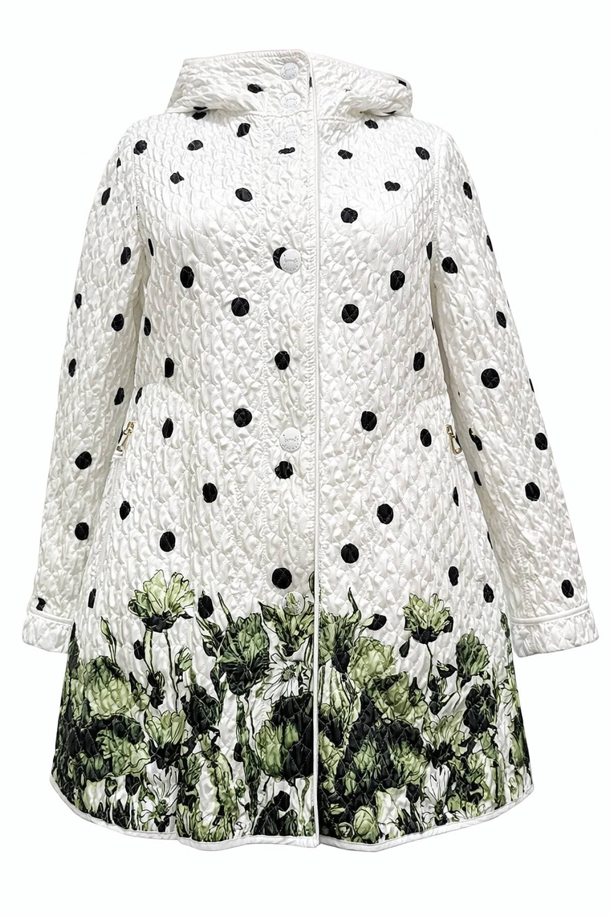 A white quilted coat with black polka dots and a green floral pattern at the bottom.