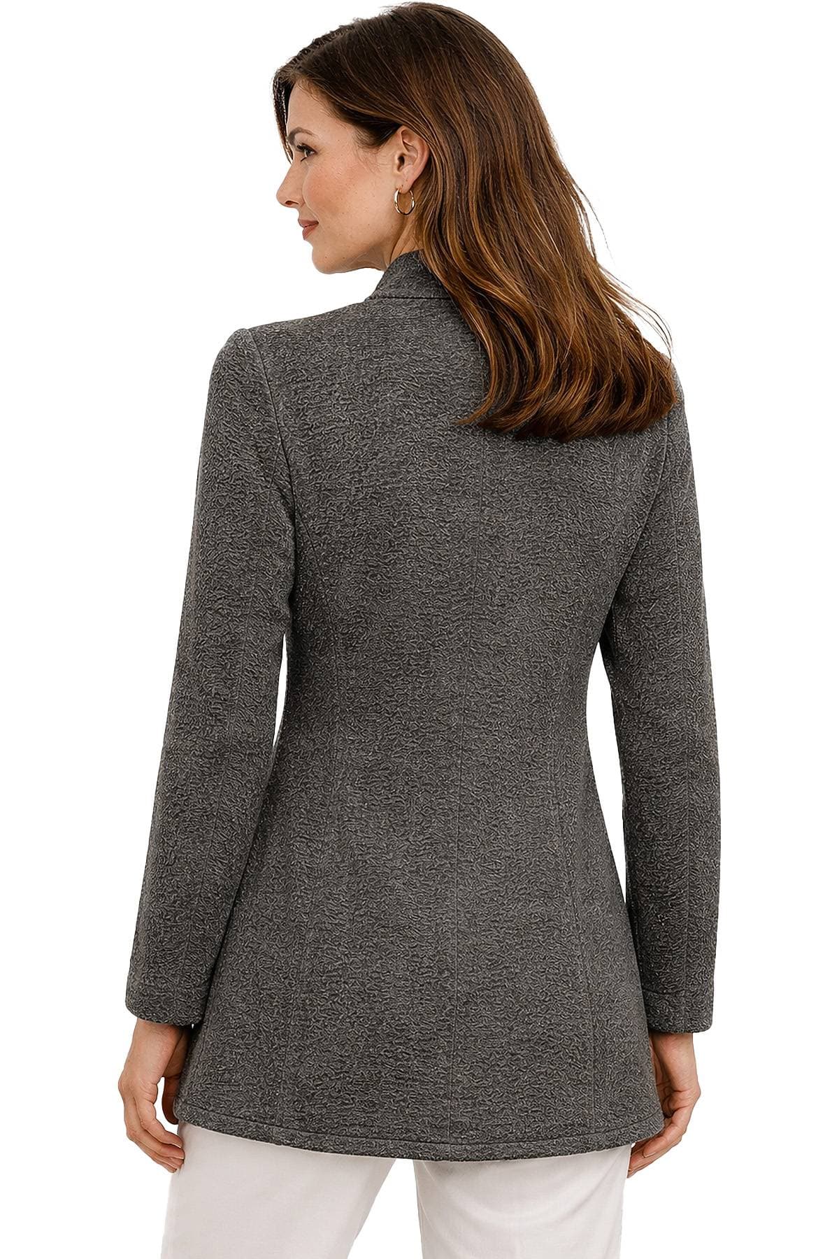 A woman wearing a textured gray blazer is turned to the side.