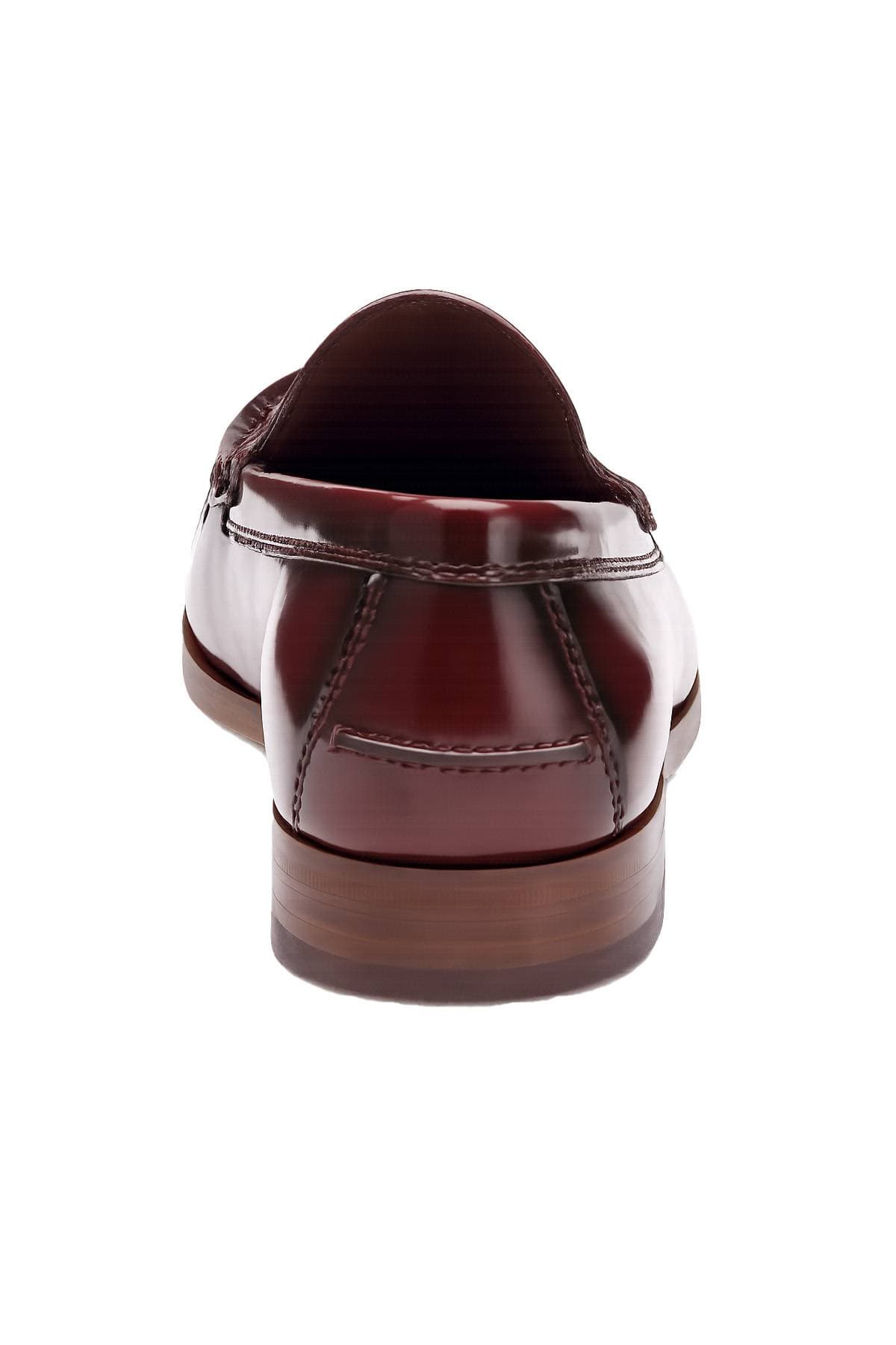 A brown leather loafer is shown from the back.