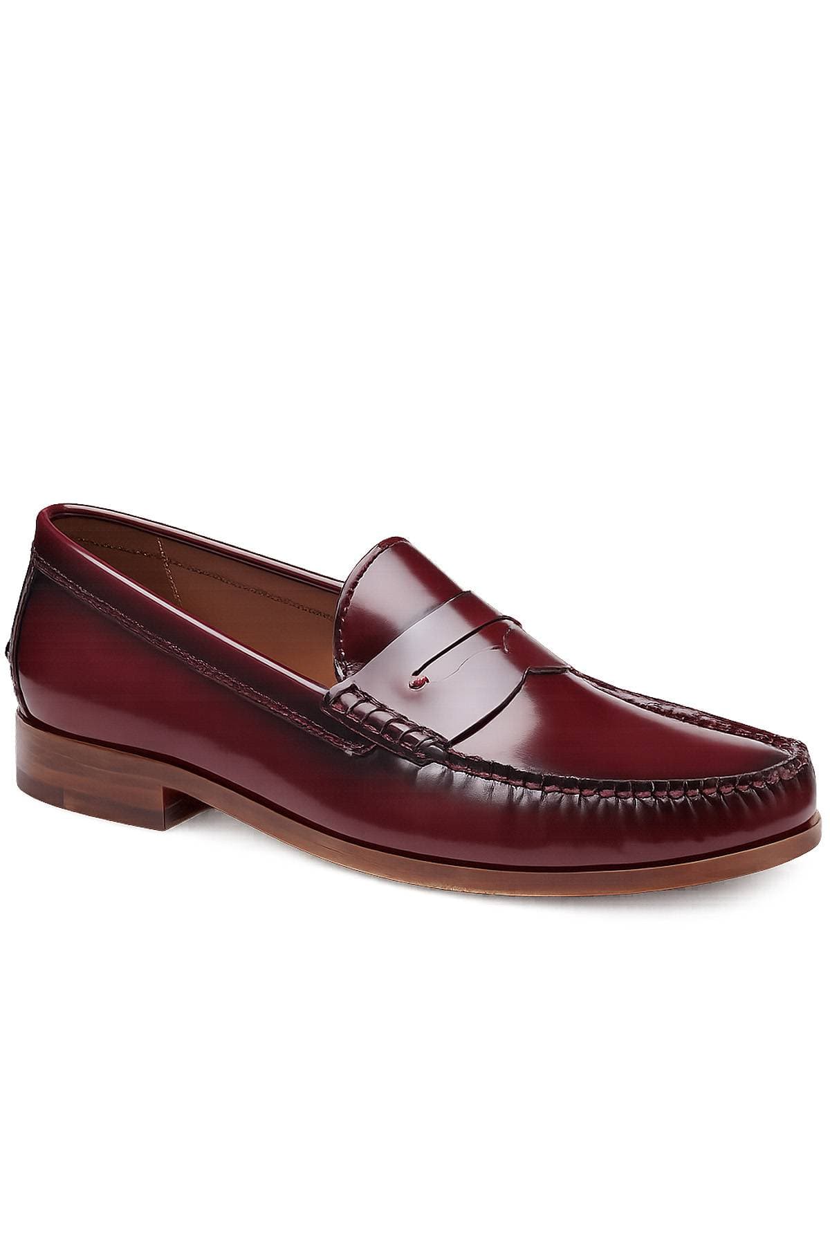A maroon leather penny loafer shoe with a low heel and stitching details.