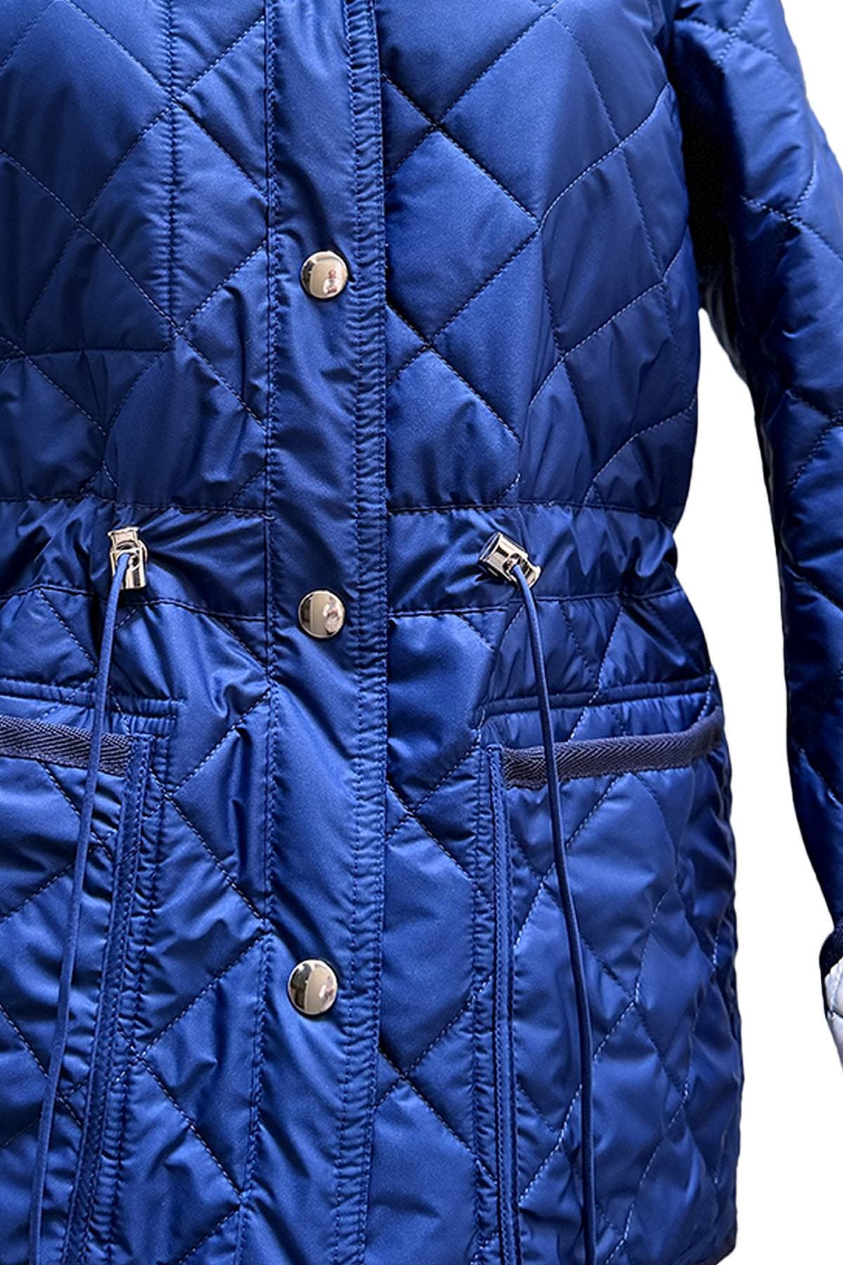 A close-up of a blue quilted jacket with metal buttons and drawstrings.
