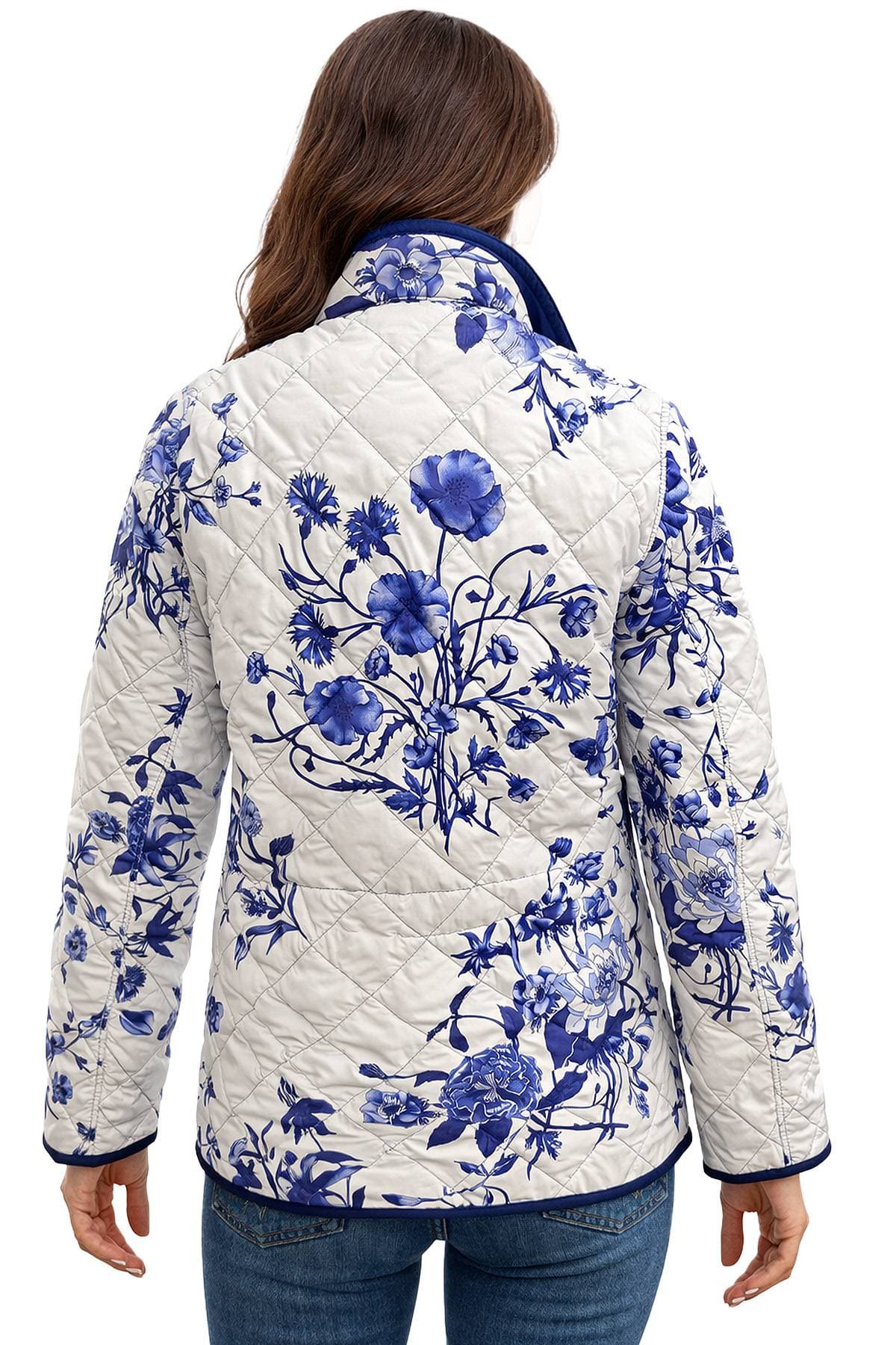 A woman wearing a quilted jacket with a blue floral pattern on a white background.
