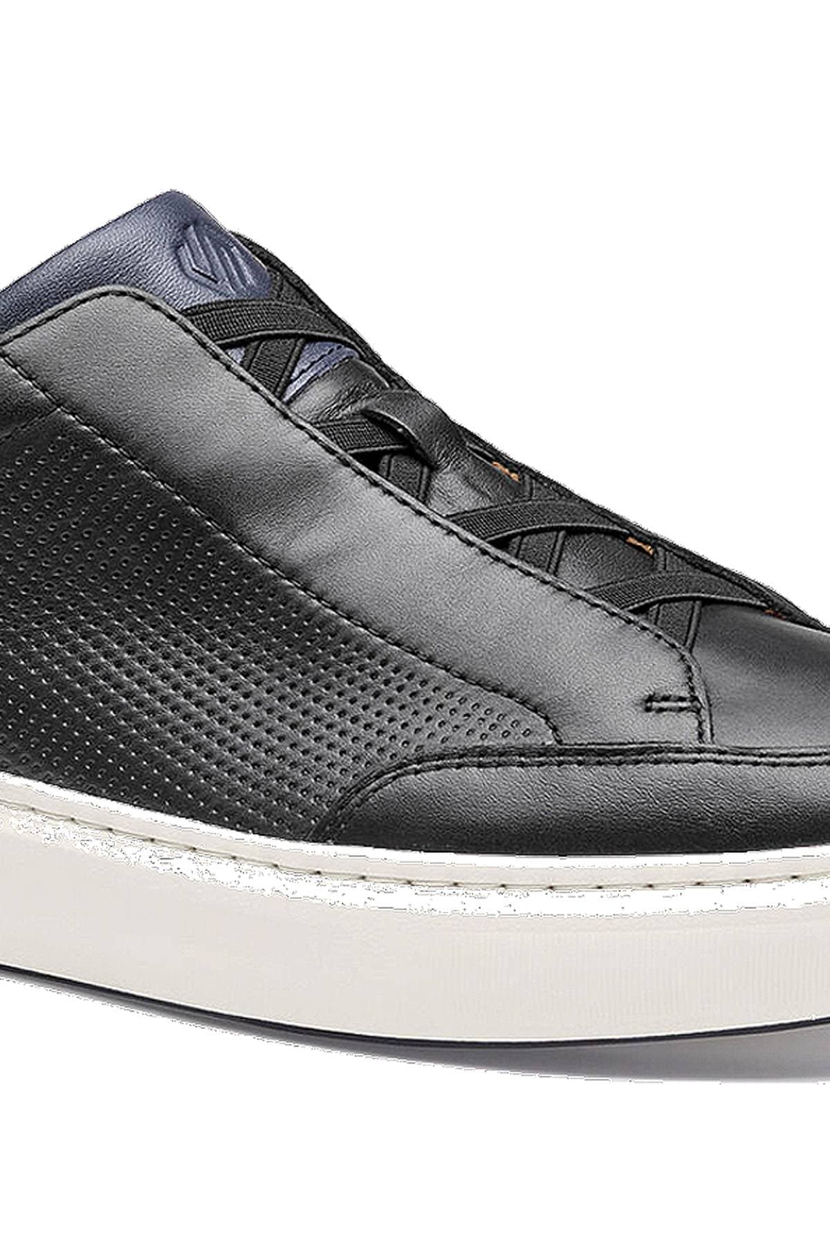 A black leather sneaker with a perforated design and white sole.