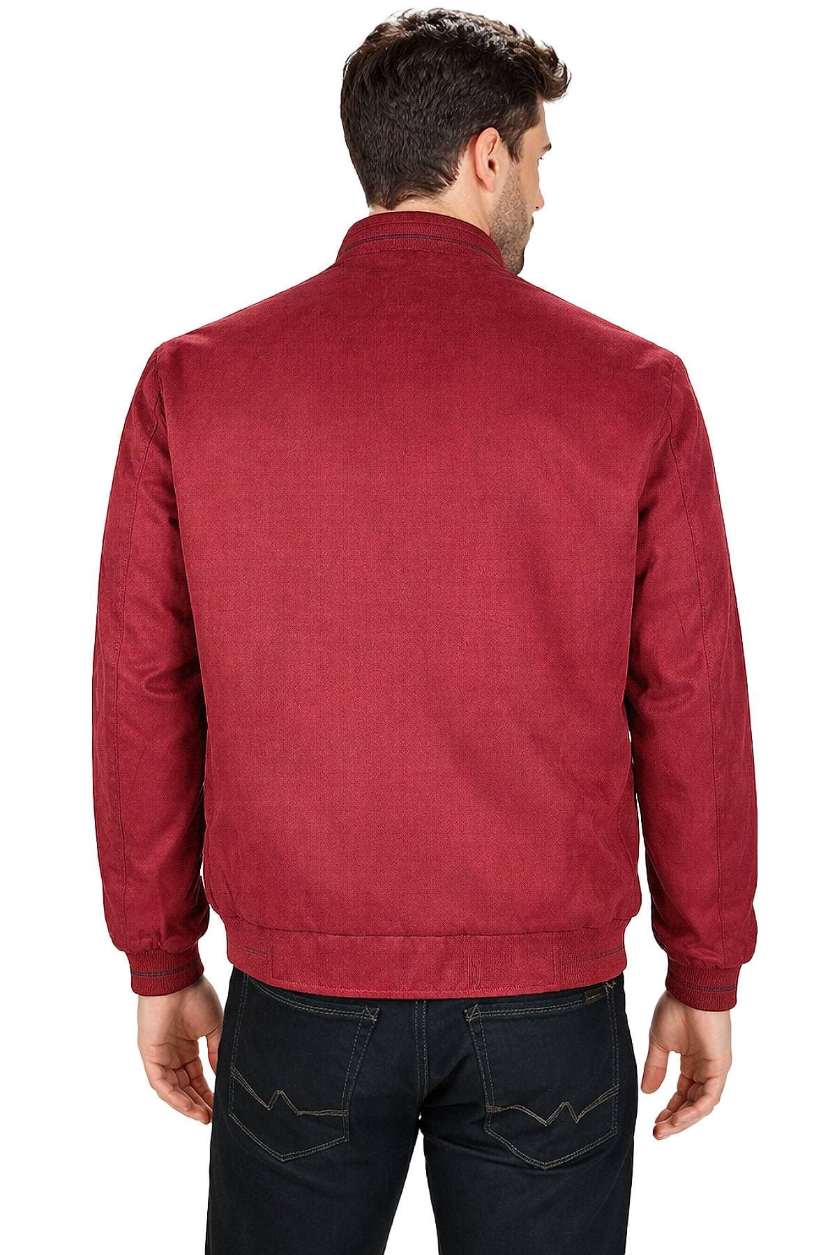 A person wearing a red jacket and black jeans is shown from behind.