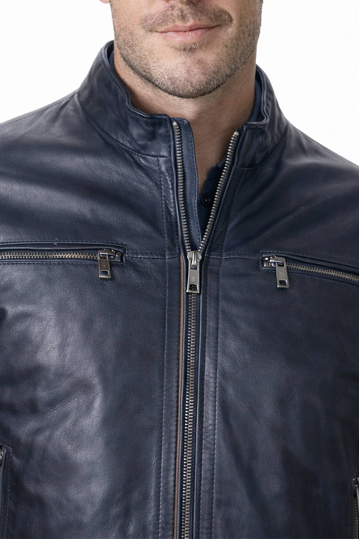A man is wearing a dark leather jacket with zippered pockets.