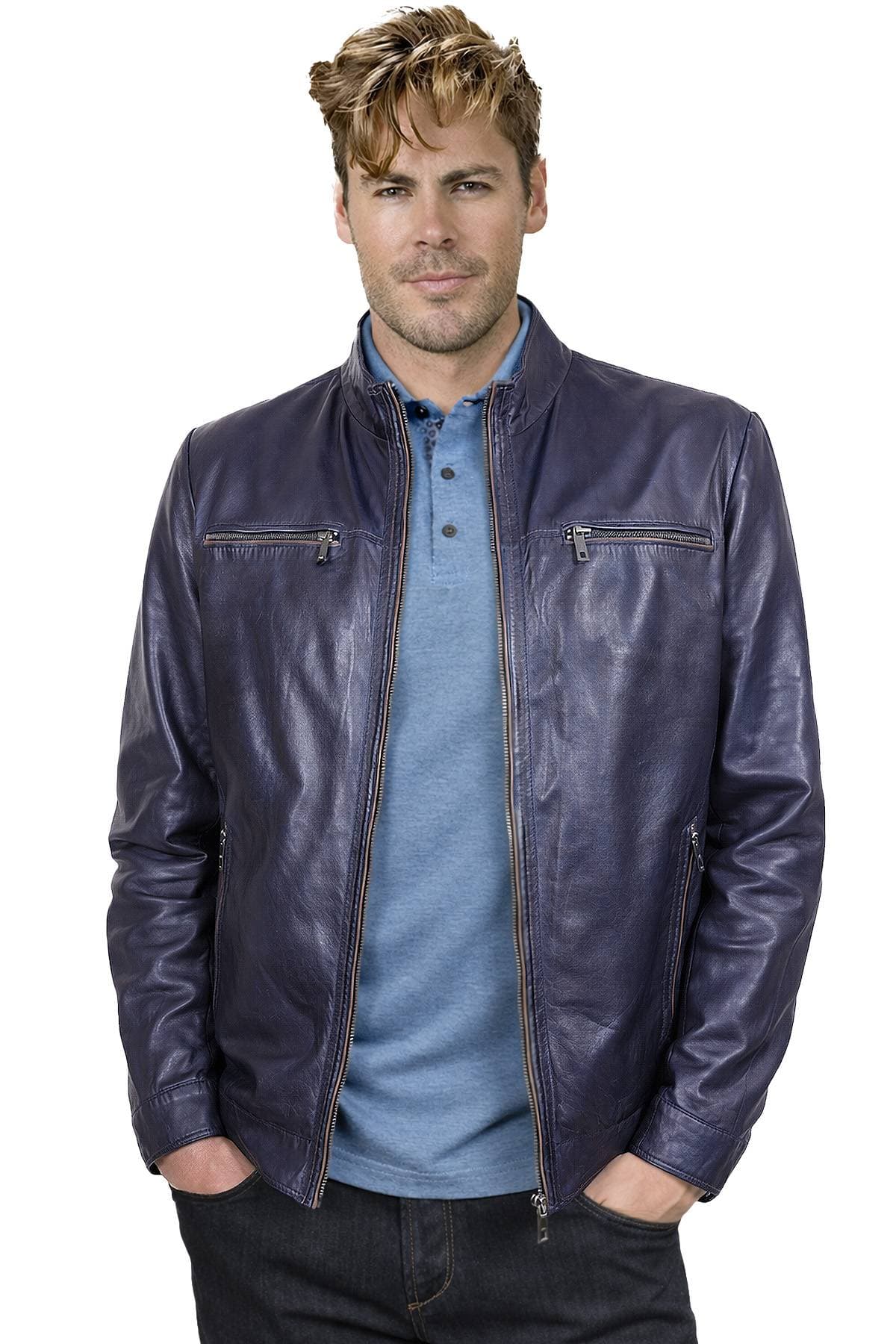A man wearing a blue leather jacket over a light blue shirt with his hands in his pockets.
