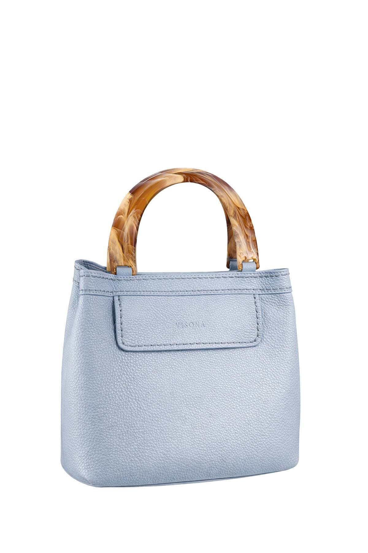 A light blue handbag with tan tortoiseshell handles.
