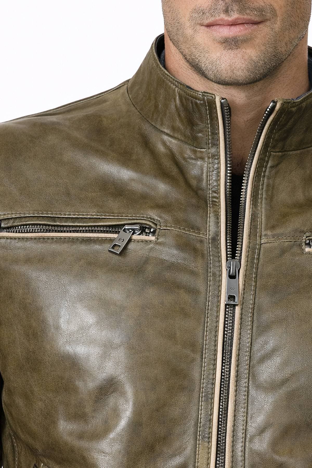 A person wearing a brown leather jacket with front zippers and a high collar.