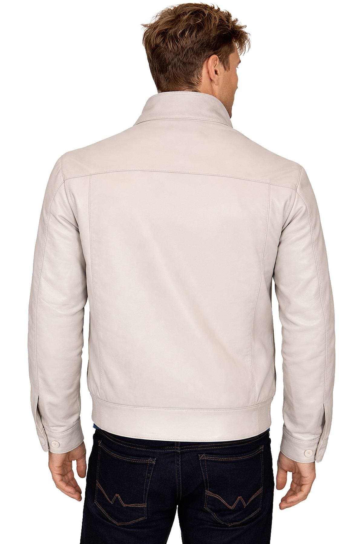 A person wearing a light-colored leather jacket and dark jeans, viewed from behind.