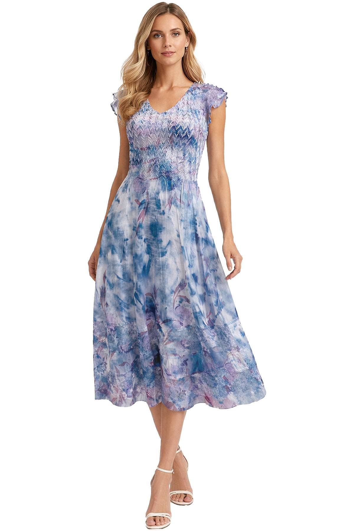 A person wearing a blue and purple floral-patterned dress with short sleeves and white sandals.