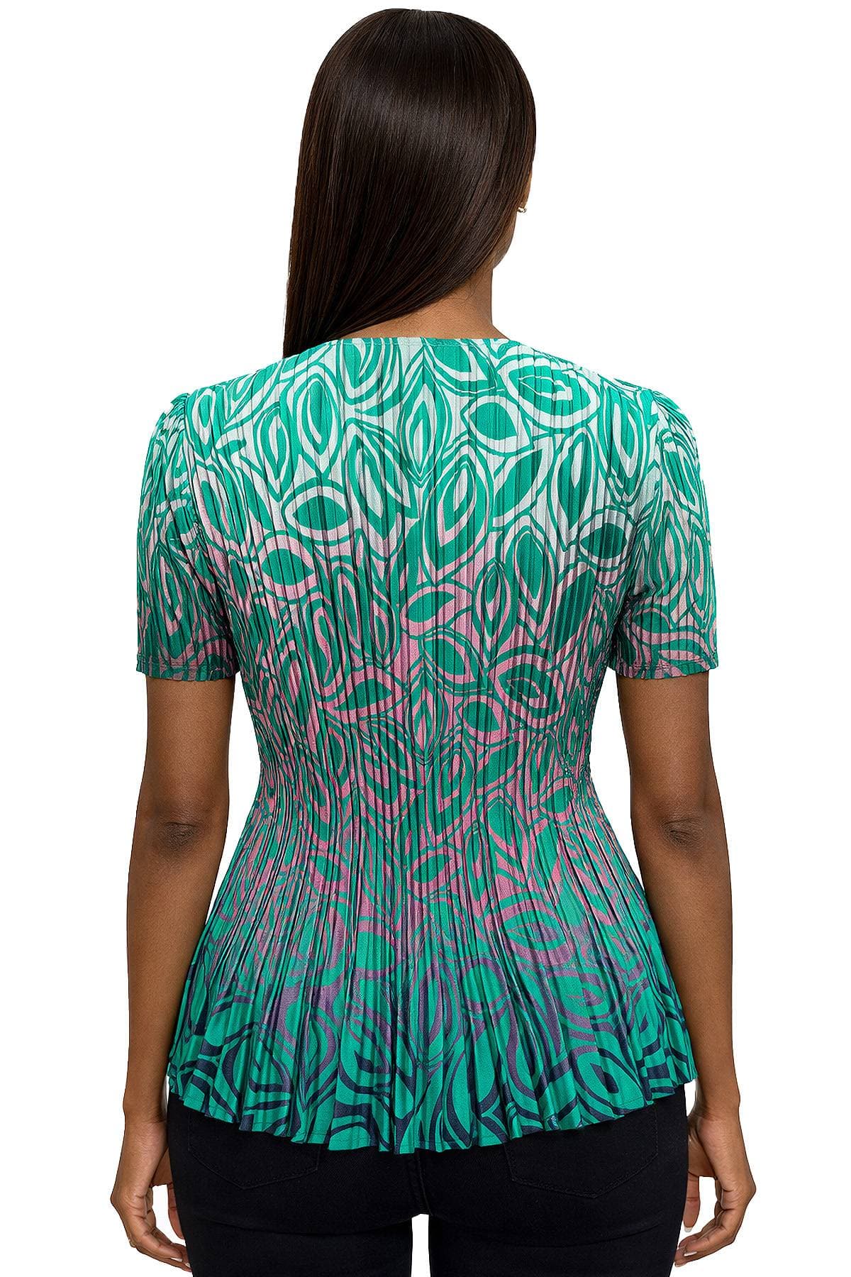 A person wearing a short-sleeved, green and pink patterned top is shown from the back.