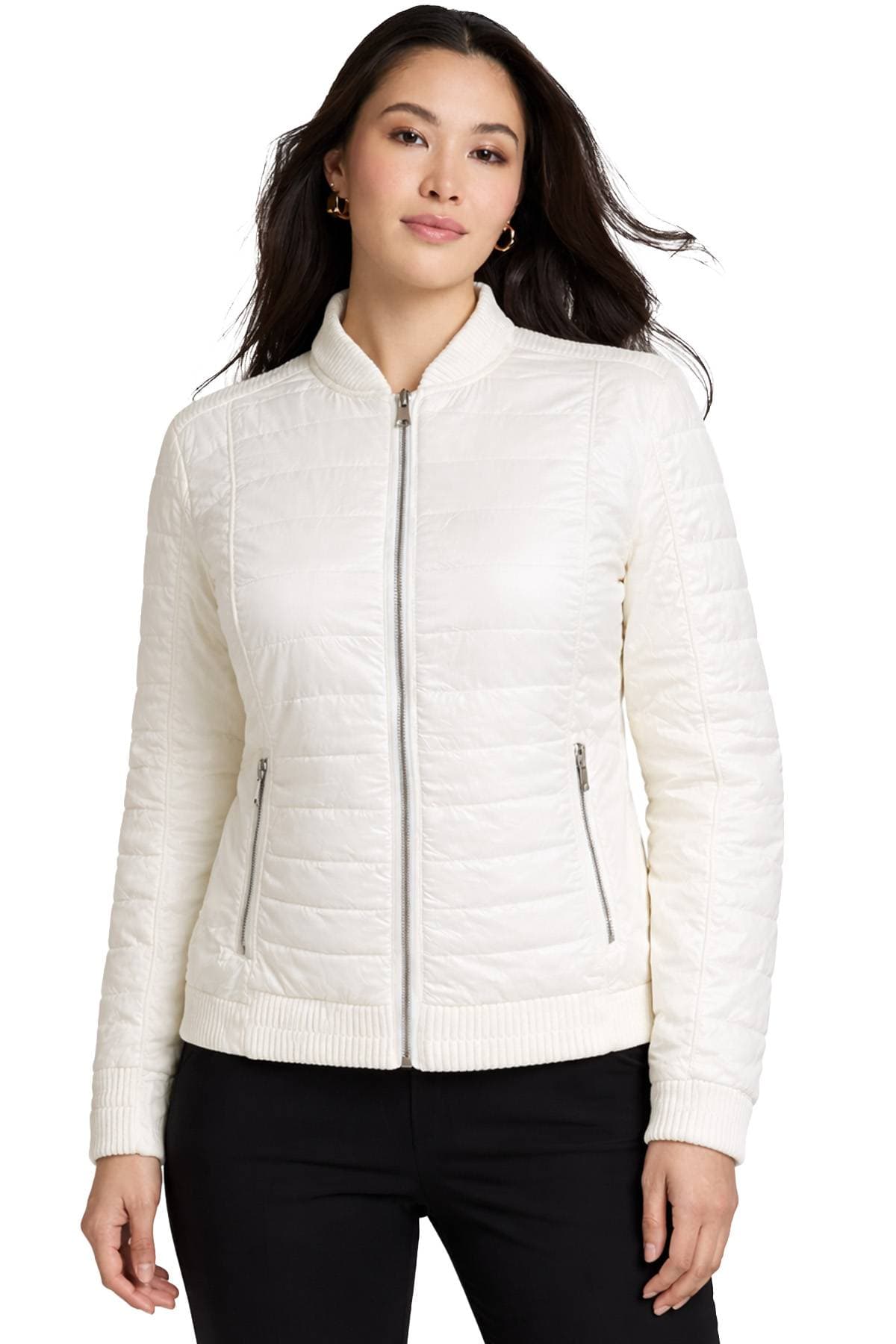 A person wearing a white quilted jacket with a front zipper.
