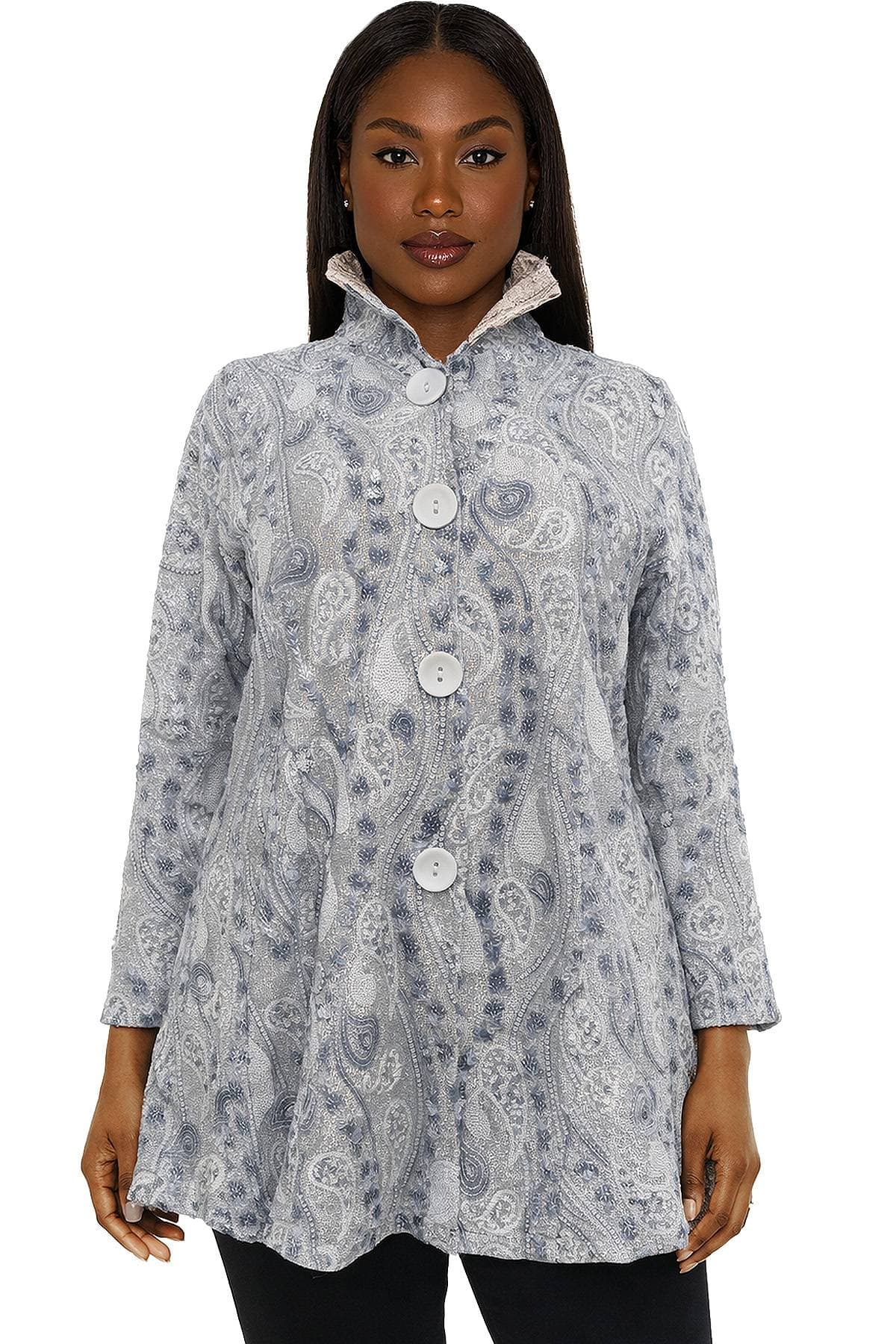 A woman wearing a patterned gray coat with large buttons.