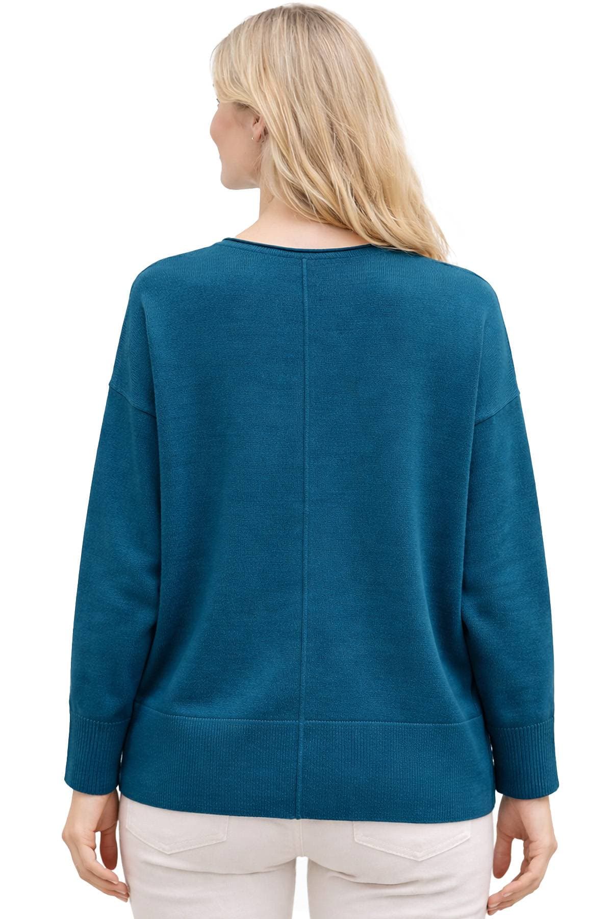 A person wearing a teal sweater with a seam down the middle of the back, viewed from behind.