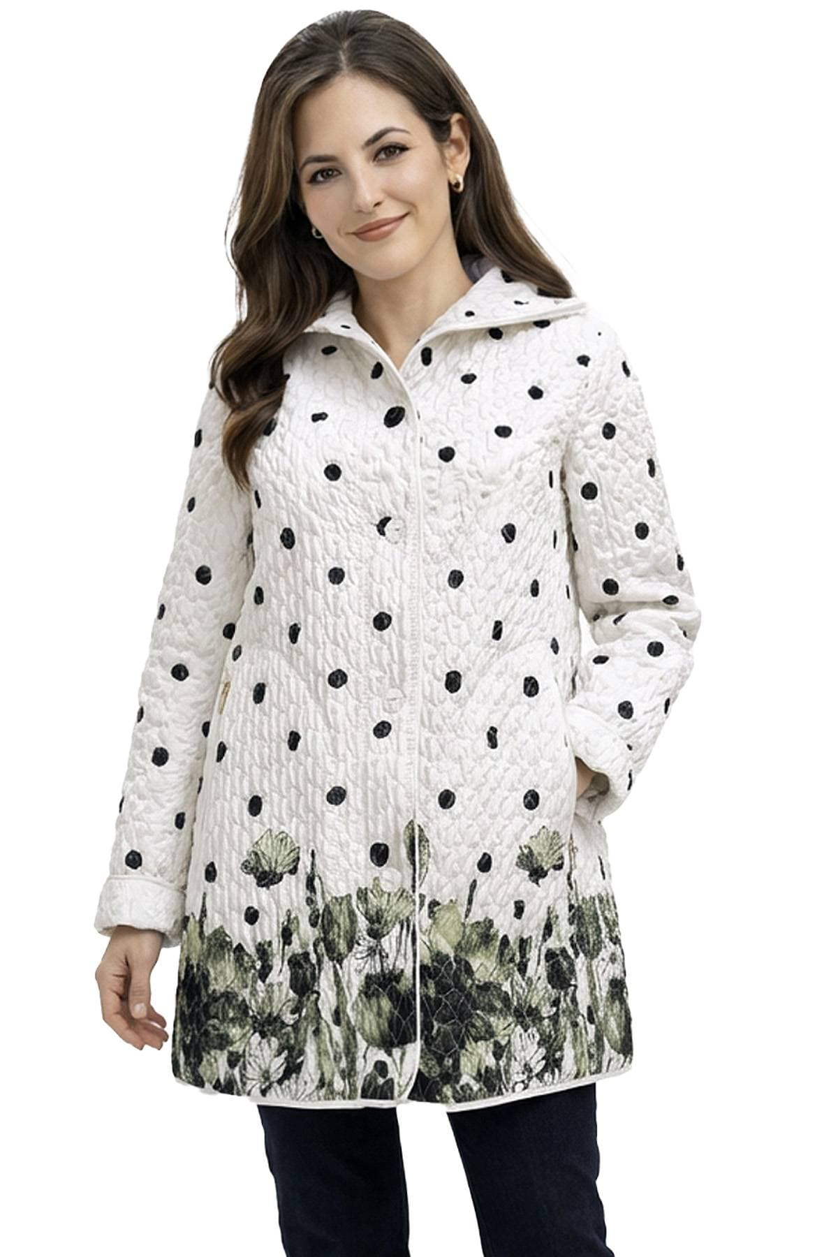 A woman wearing a white quilted coat with black polka dots and a floral pattern at the hem.