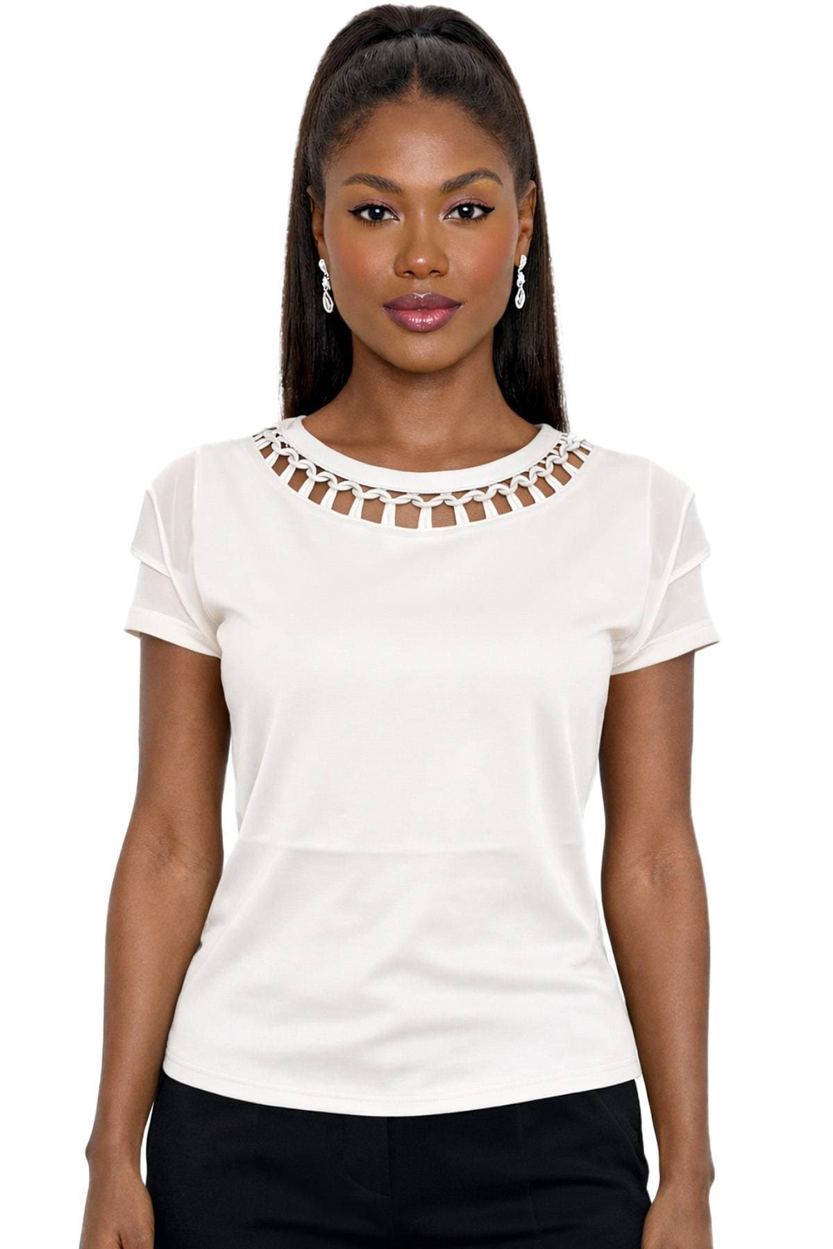 A person wearing a white top with a decorative neckline and drop earrings.