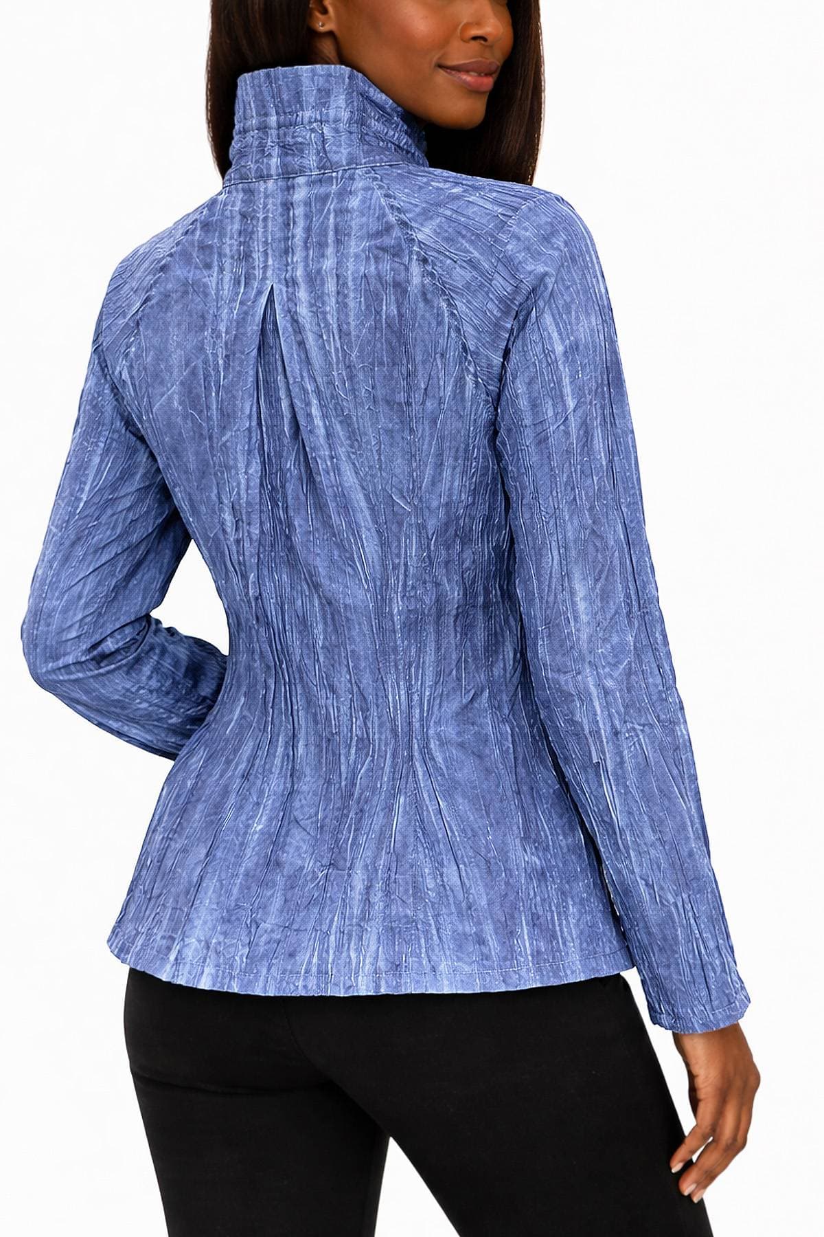 A person wearing a blue, textured long-sleeve top with a high collar is facing away.