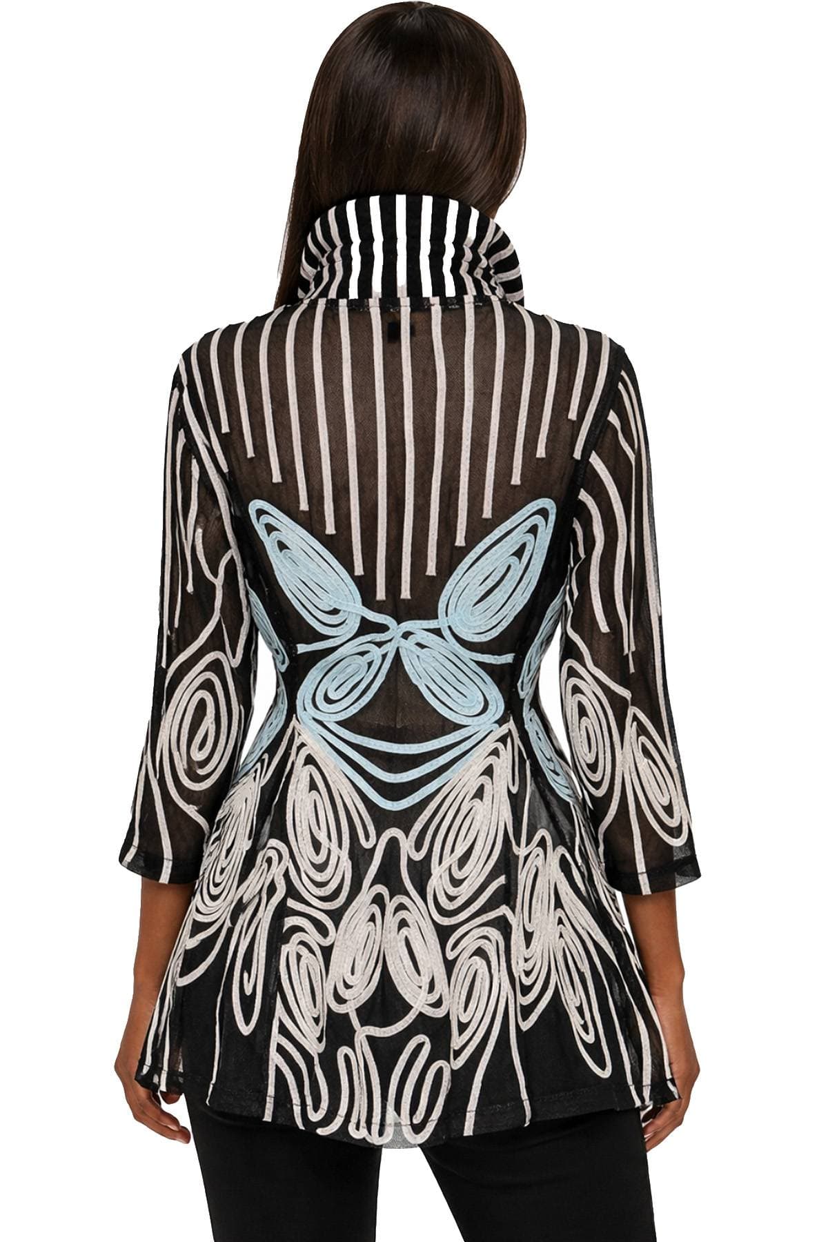 A woman wearing a black tunic with blue and white abstract patterns and a striped collar.
