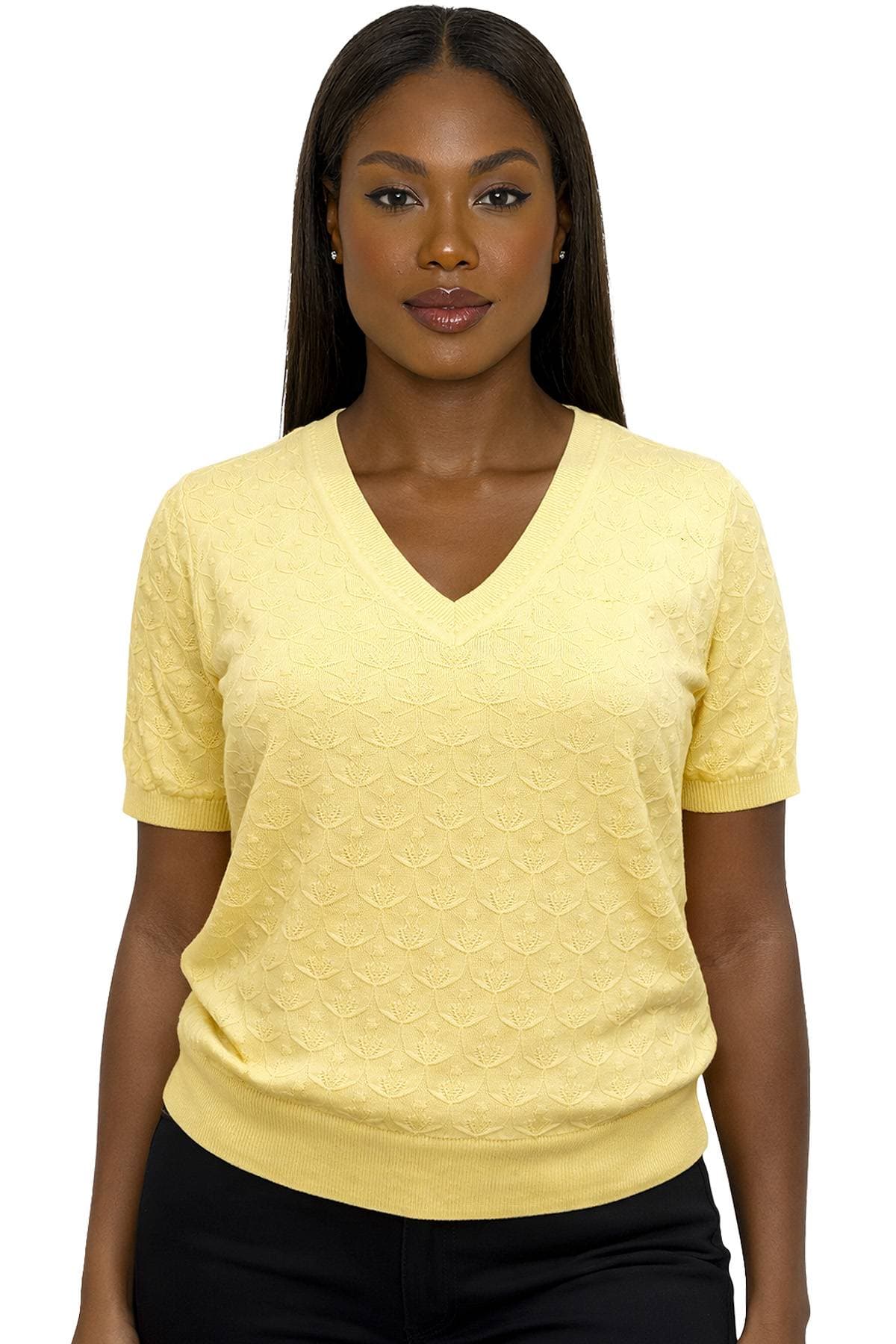 A woman wearing a yellow embossed short-sleeve V-neck sweater.