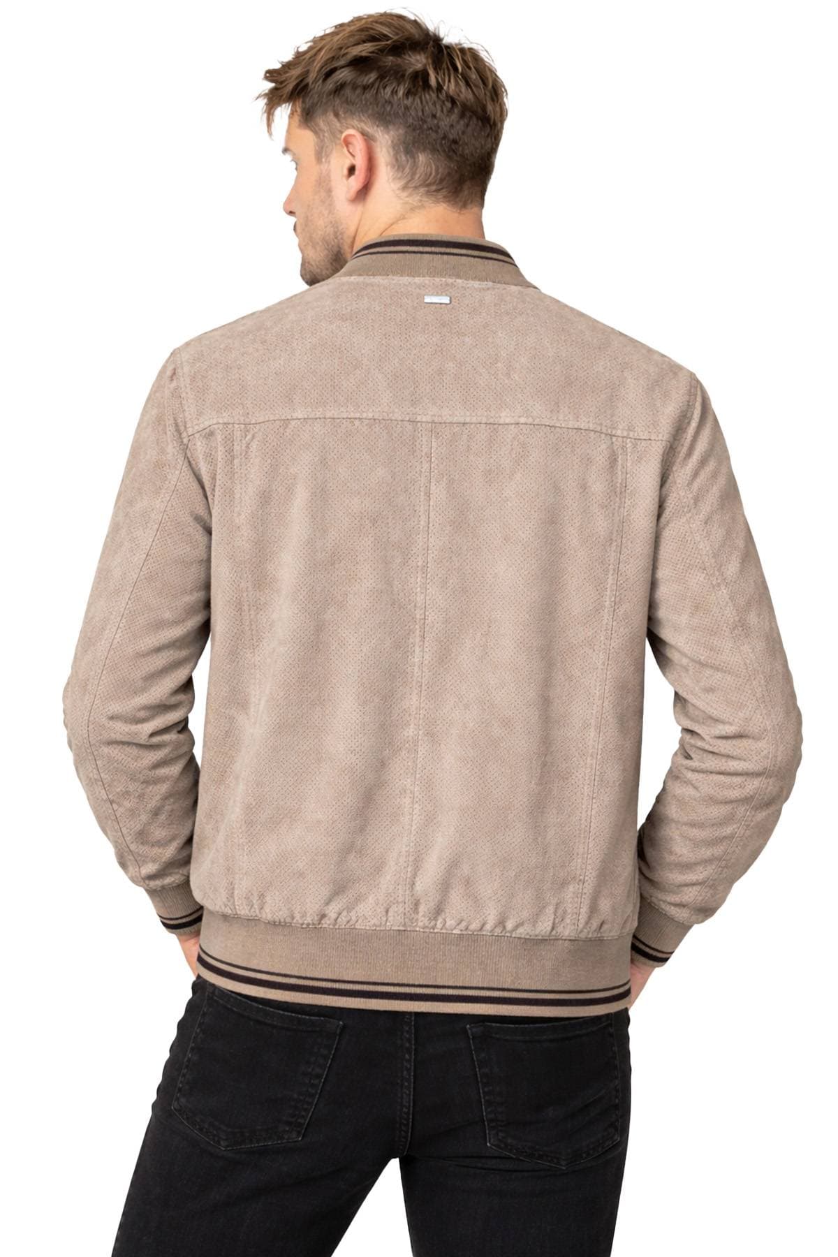 A man facing away, wearing a beige jacket with ribbed cuffs.