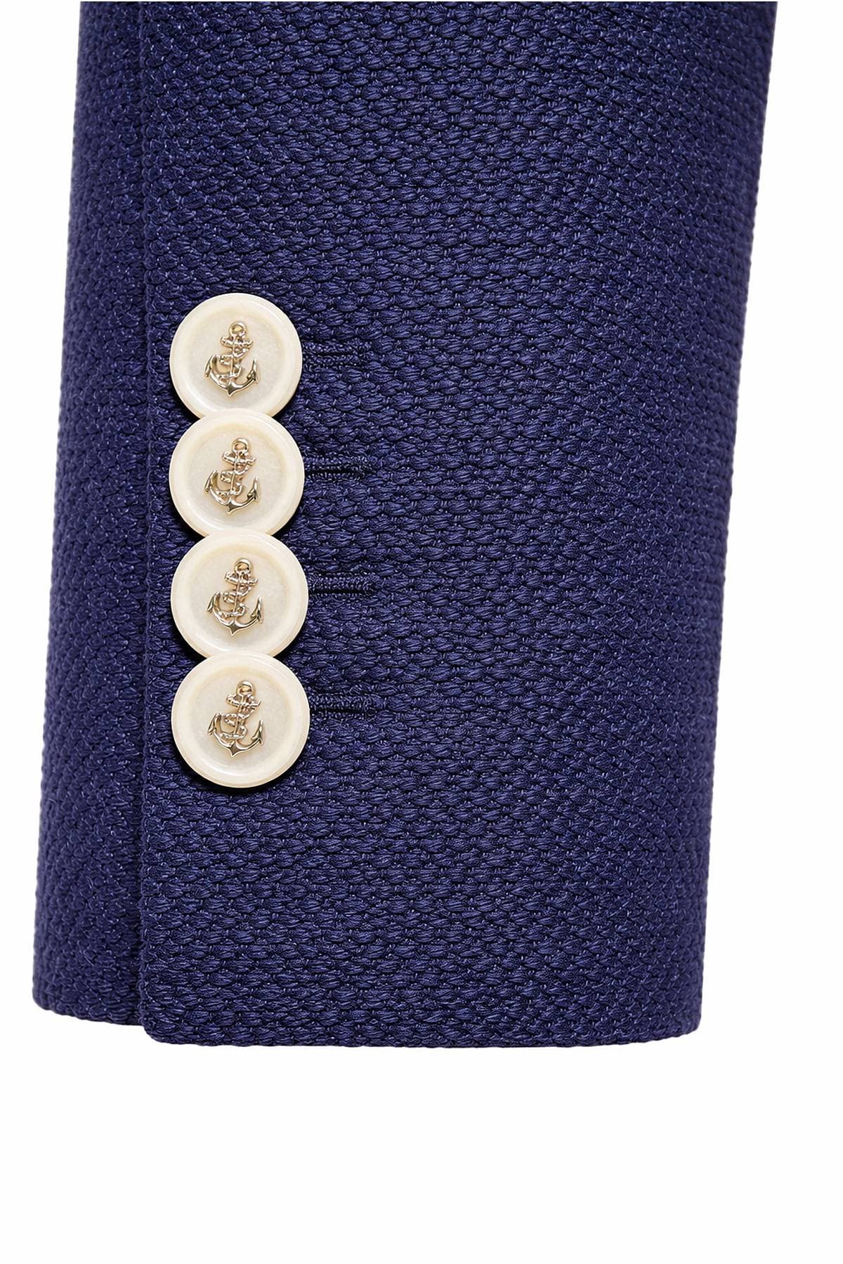 A navy blue jacket sleeve with four white buttons featuring anchor designs.
