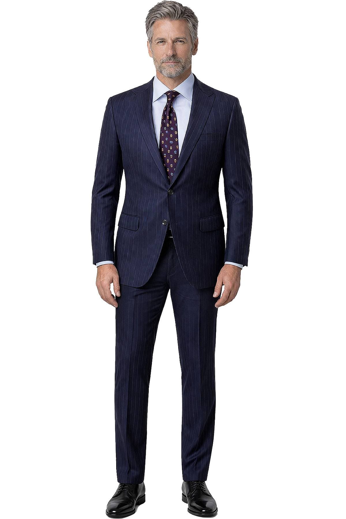 A man wearing a navy pinstripe suit with a white shirt and a patterned tie.