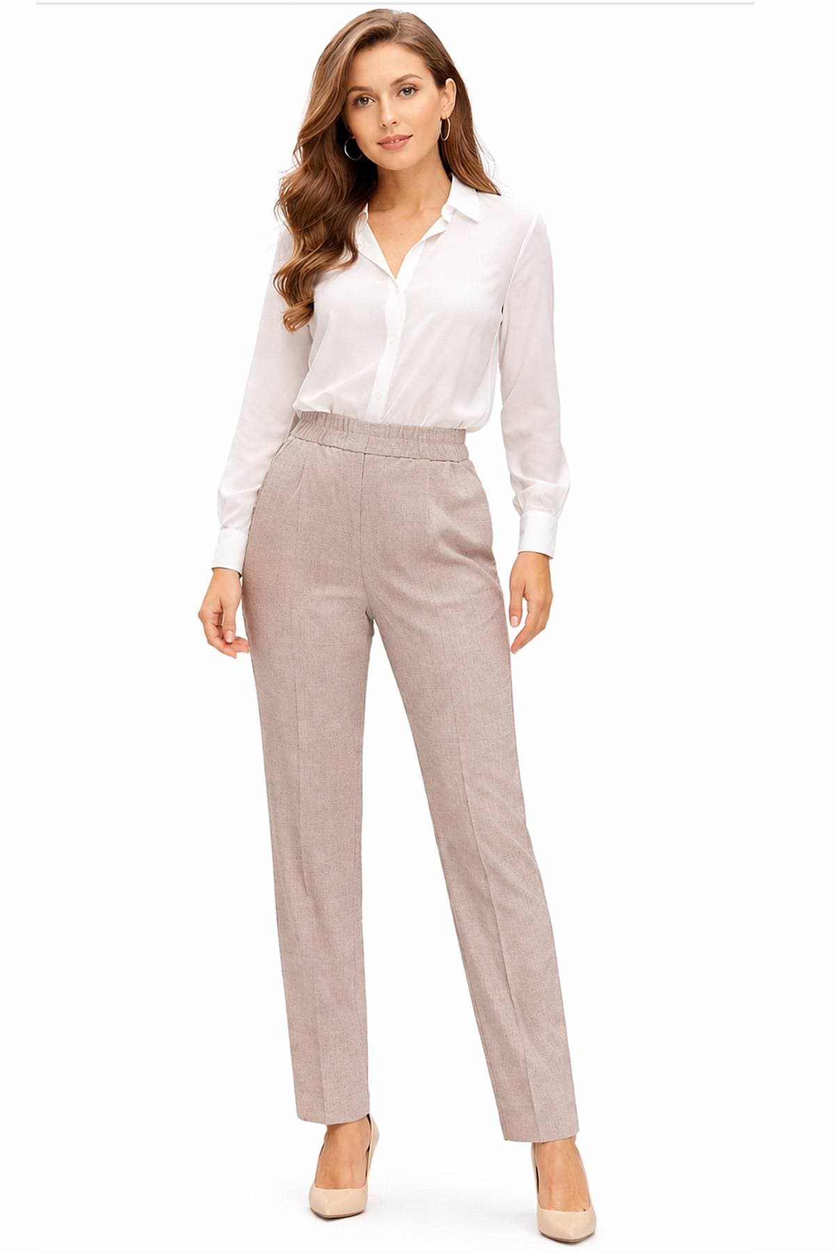 A woman is wearing a white blouse and beige trousers.