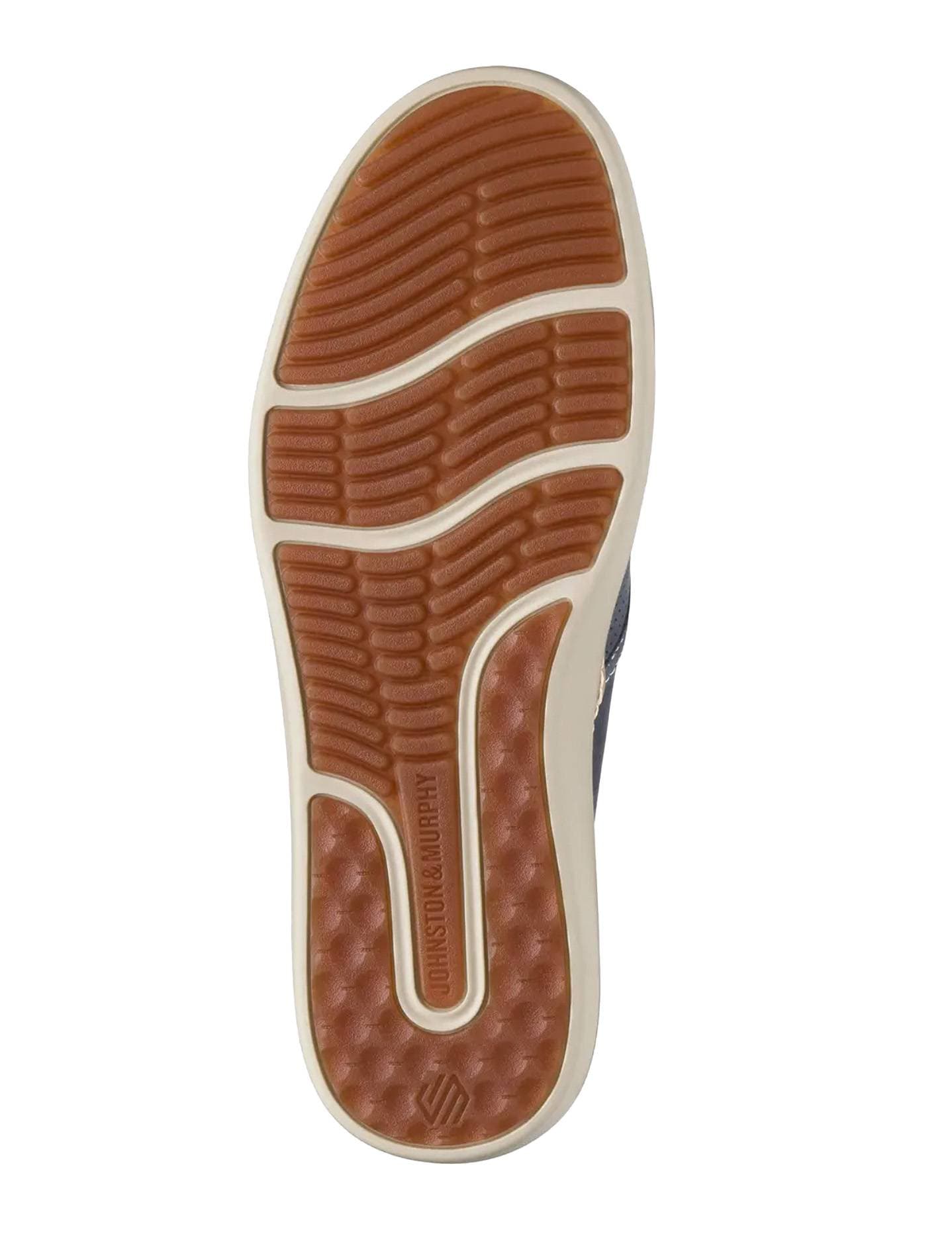 A shoe sole with a patterned tread design and the brand name "Johnston & Murphy" imprinted on it.