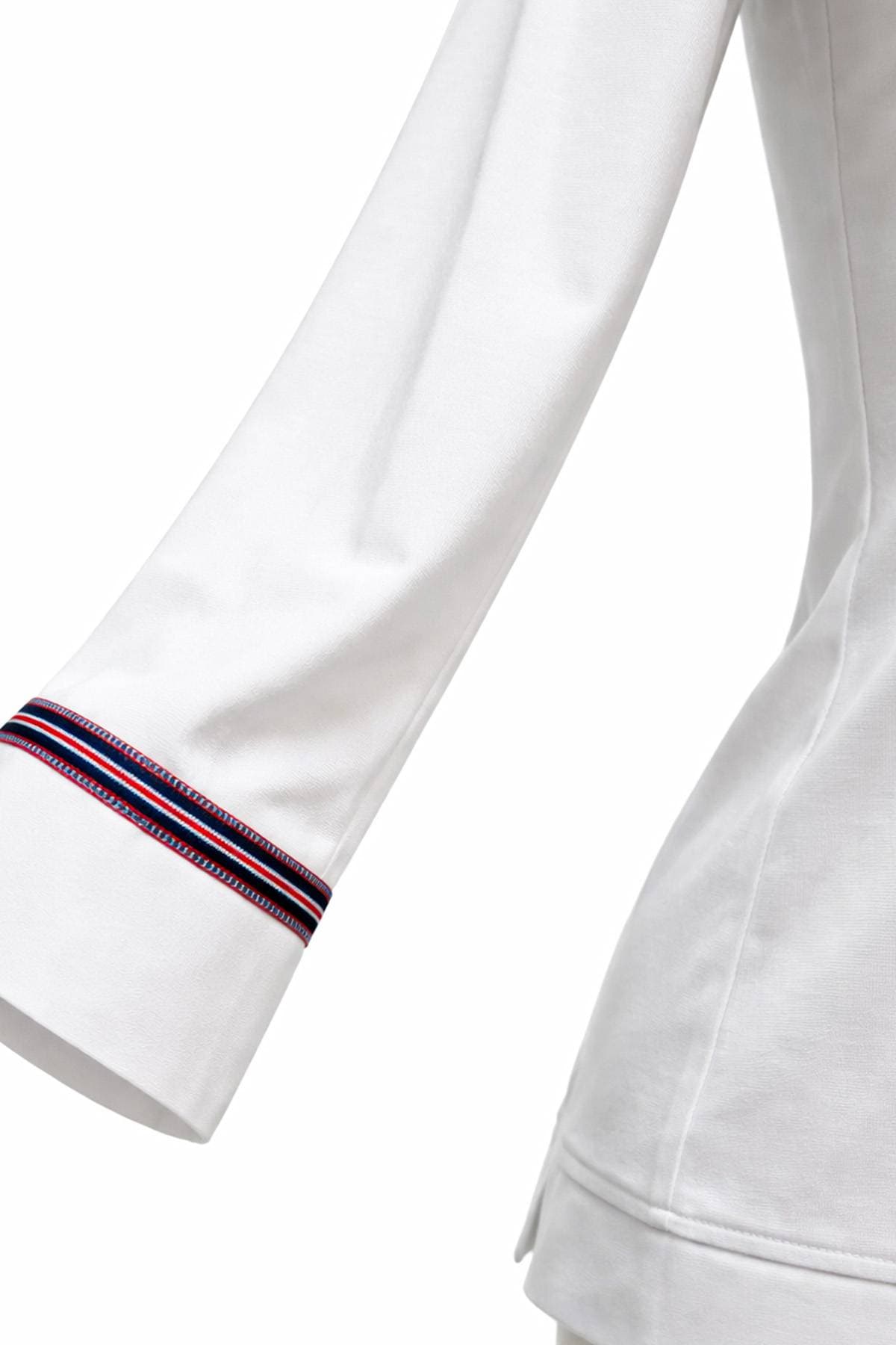 A close-up of a white long-sleeved garment with blue and red striped trim near the cuff.