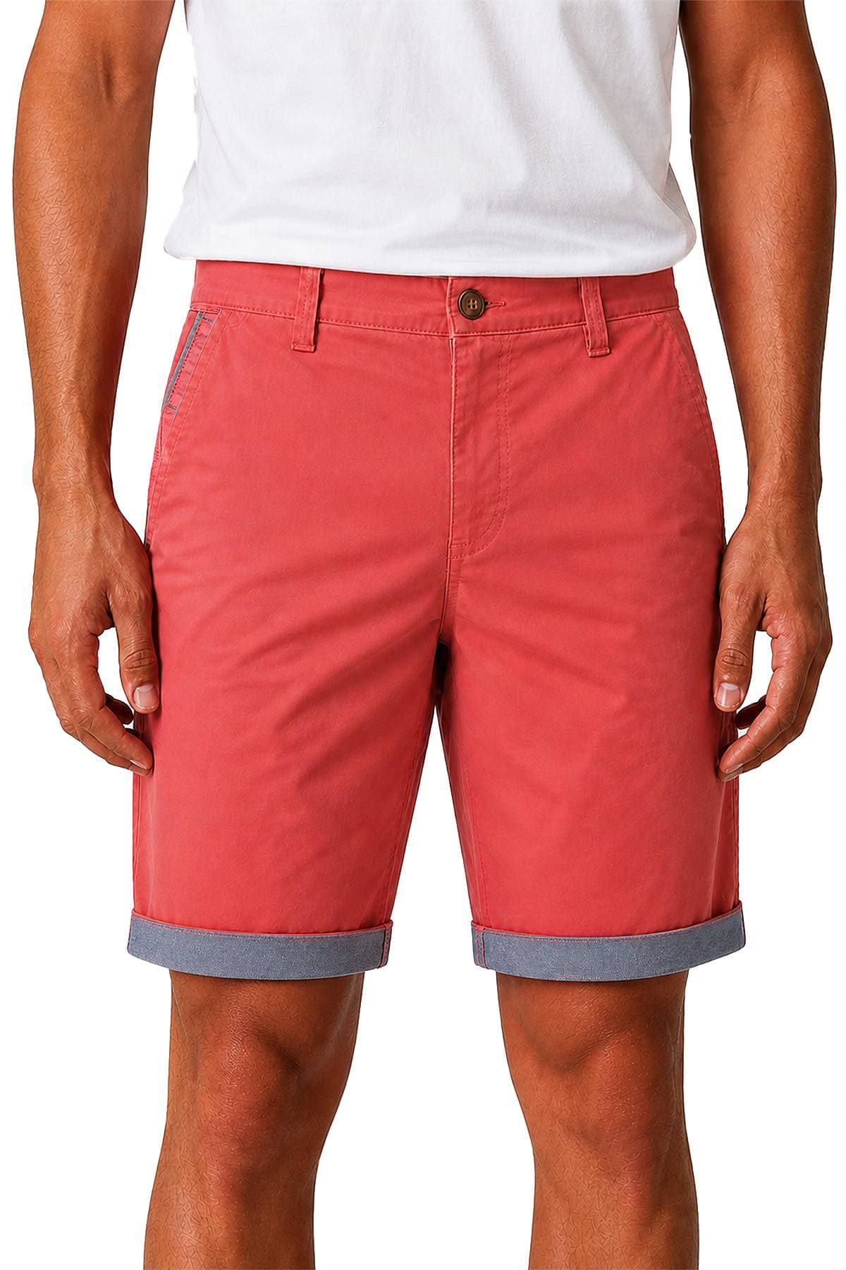 A person wearing pink shorts with rolled cuffs and a white T-shirt.