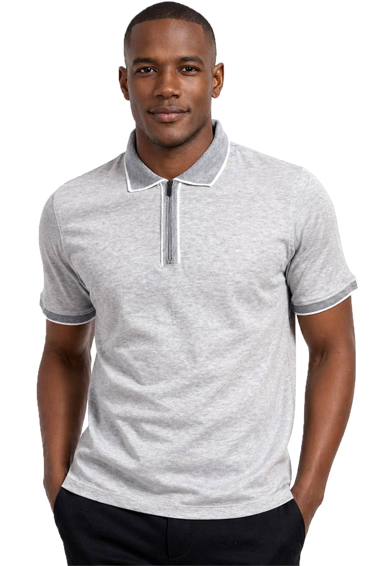 A person wearing a light gray short-sleeve polo shirt with a zip-up collar, standing with hands in pockets.