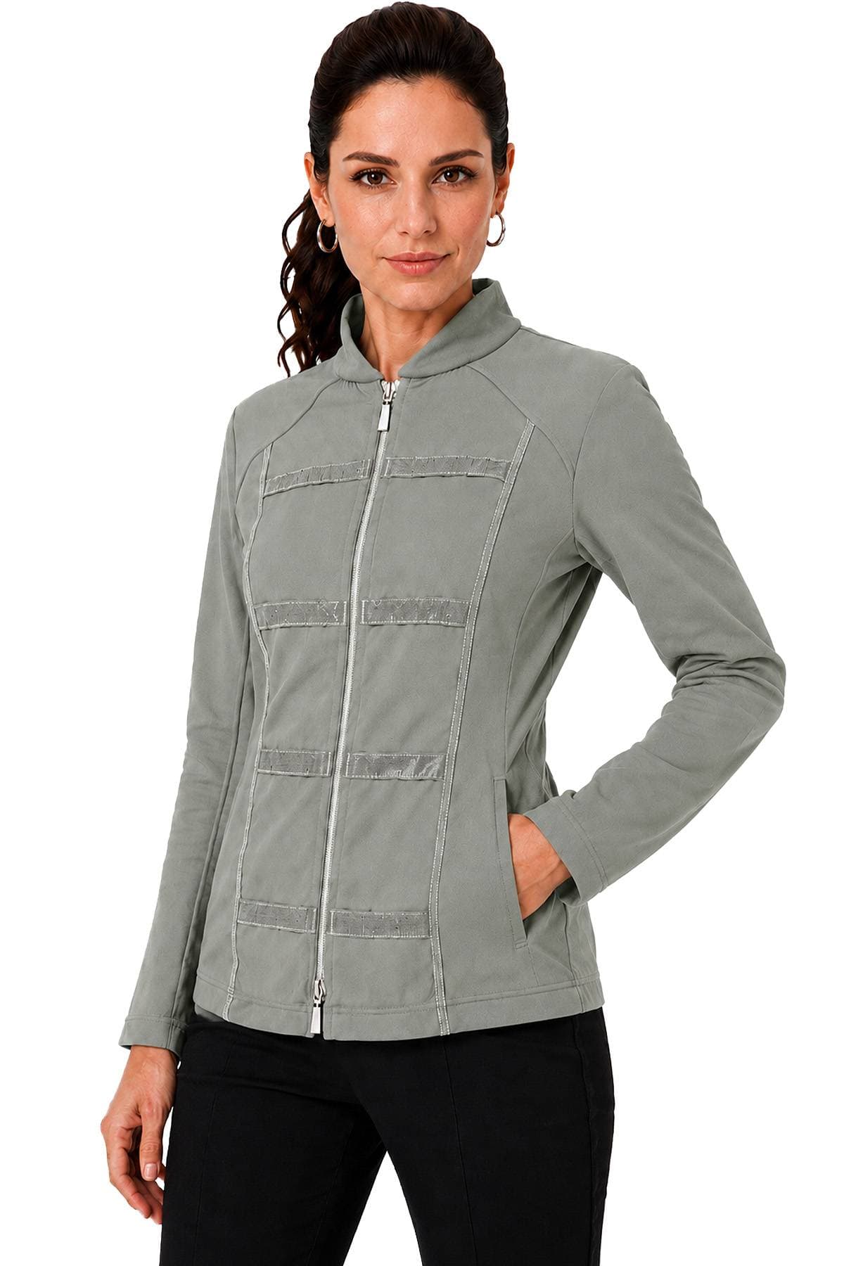 A woman wearing a gray zip-up jacket with her hand in the pocket.
